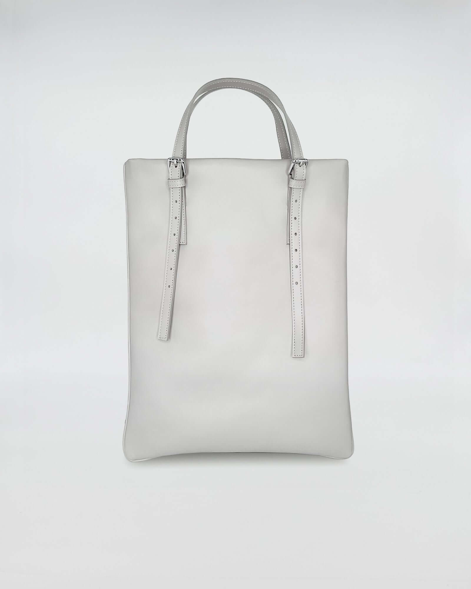 AMELIE PORTACOMPUTER in elegant grey leather, featuring minimalist design and versatile handles.