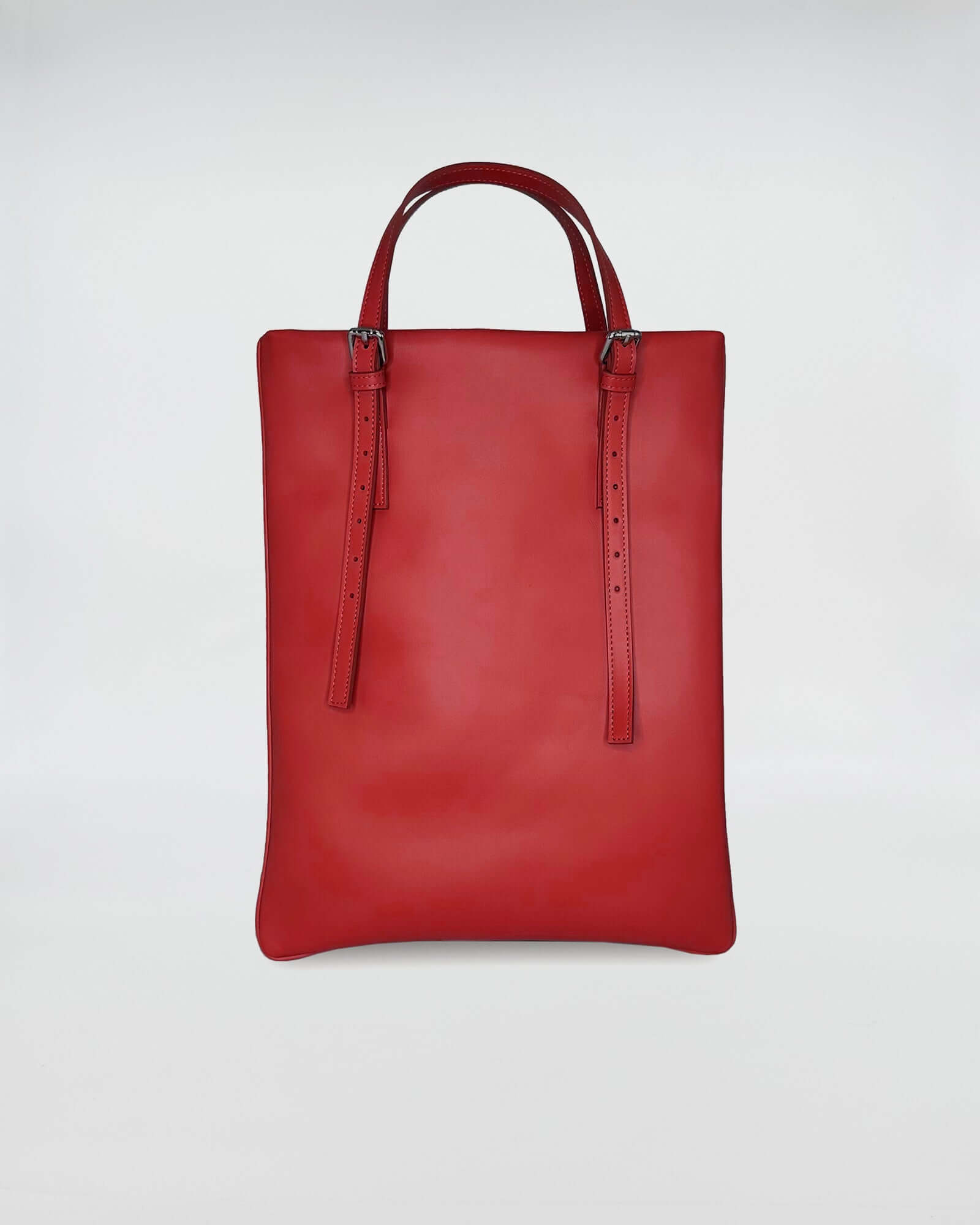 AMELIE PORTACOMPUTER red leather bag with dual handles and a sleek design, perfect for work and style.