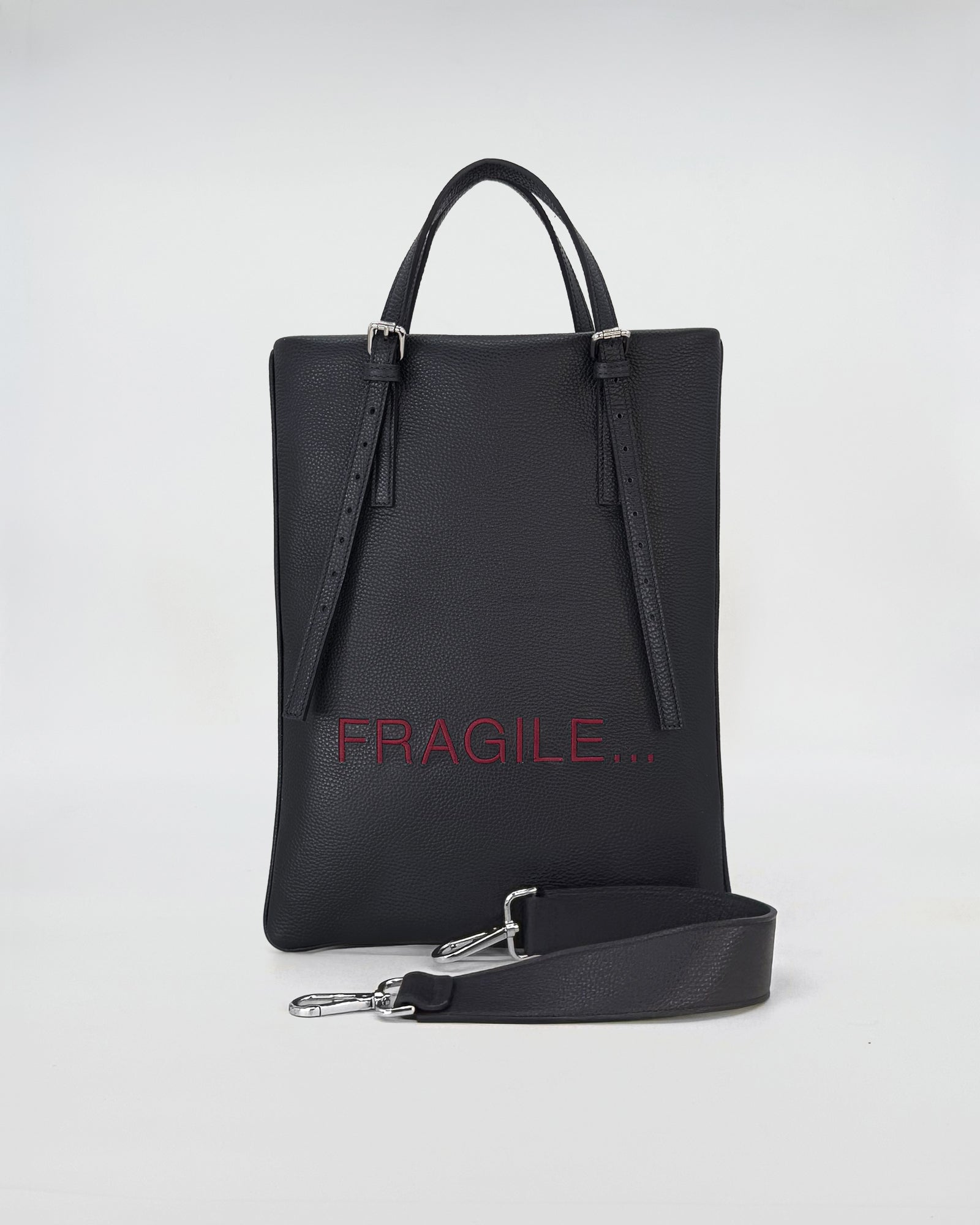 AMELIE PORTACOMPUTER in black leather with adjustable straps and fragile print design.