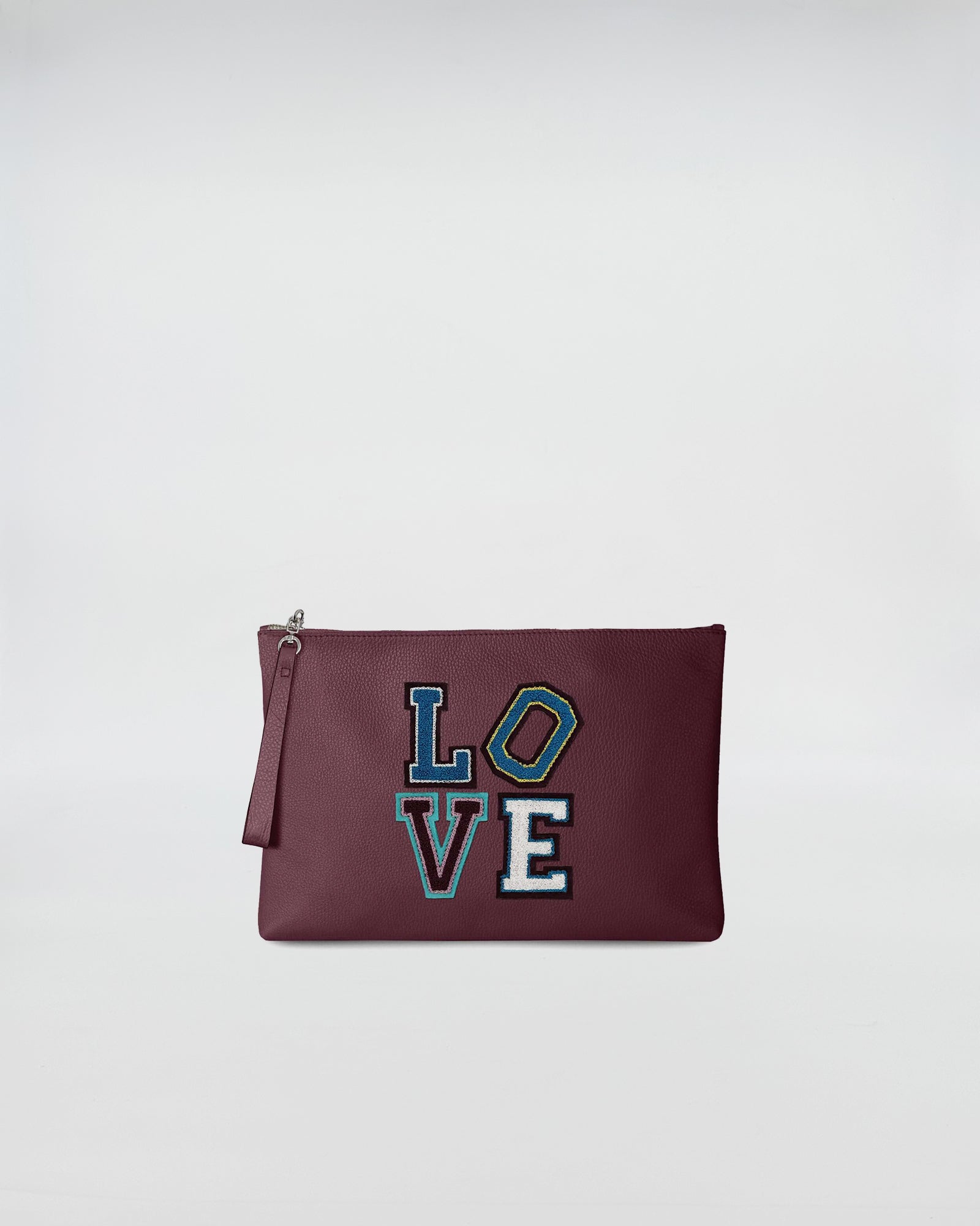 BUSTA A4 LOVE burgundy pouch with colorful LOVE patch and zip closure, showcasing a minimal and practical design.