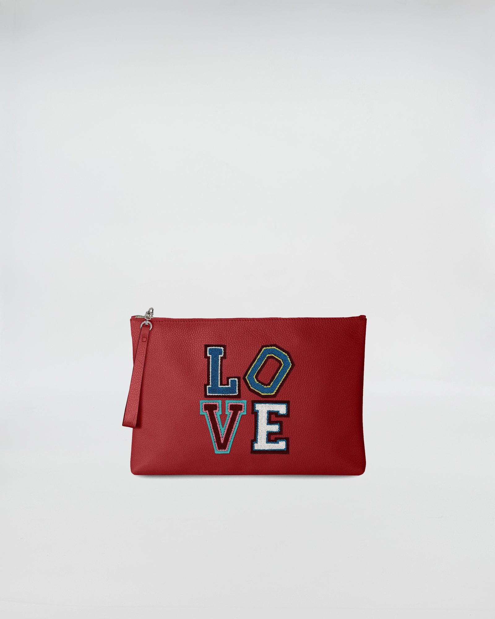 BUSTA A4 LOVE red bag with colorful LOVE patch, featuring a minimal design and zip closure.