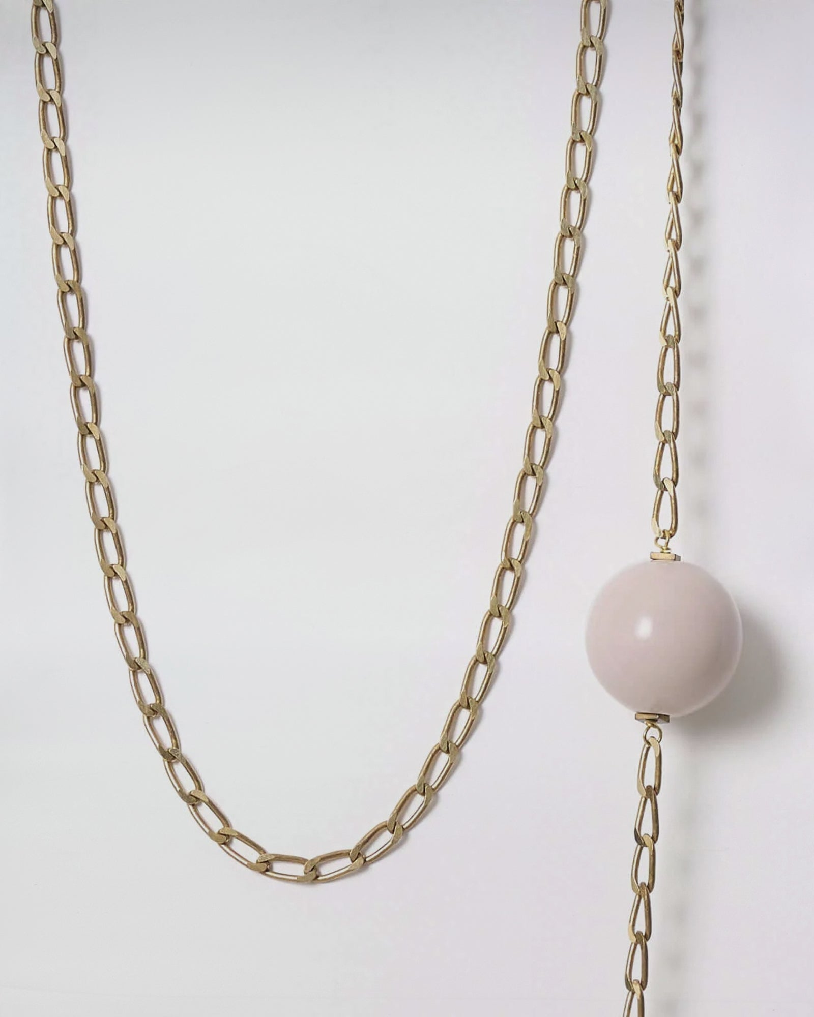 COLLANA MOD. 32 with brass chains and a pink resin boule, showcasing vintage elegance in a modern design.