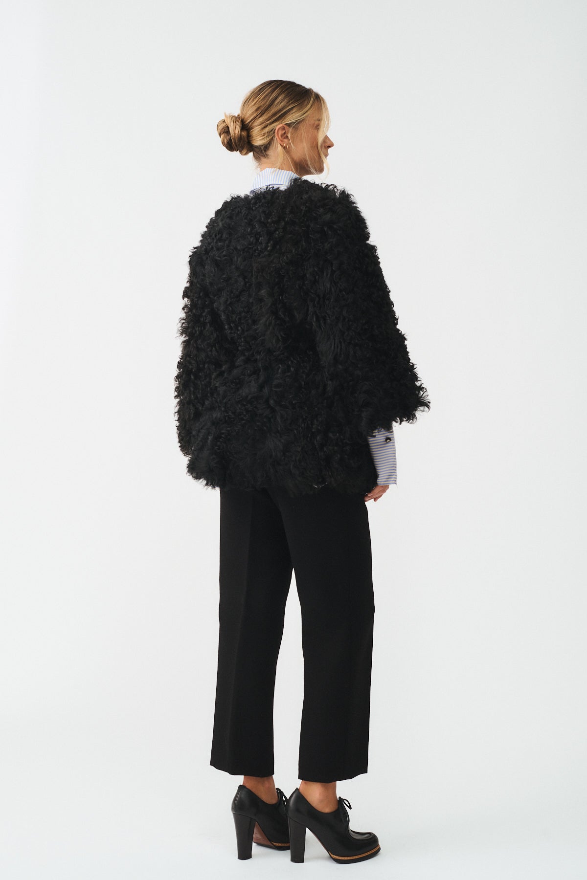 Caban in KALGAN UPCYCLE, showcasing a bold black design and contemporary silhouette from a back view.