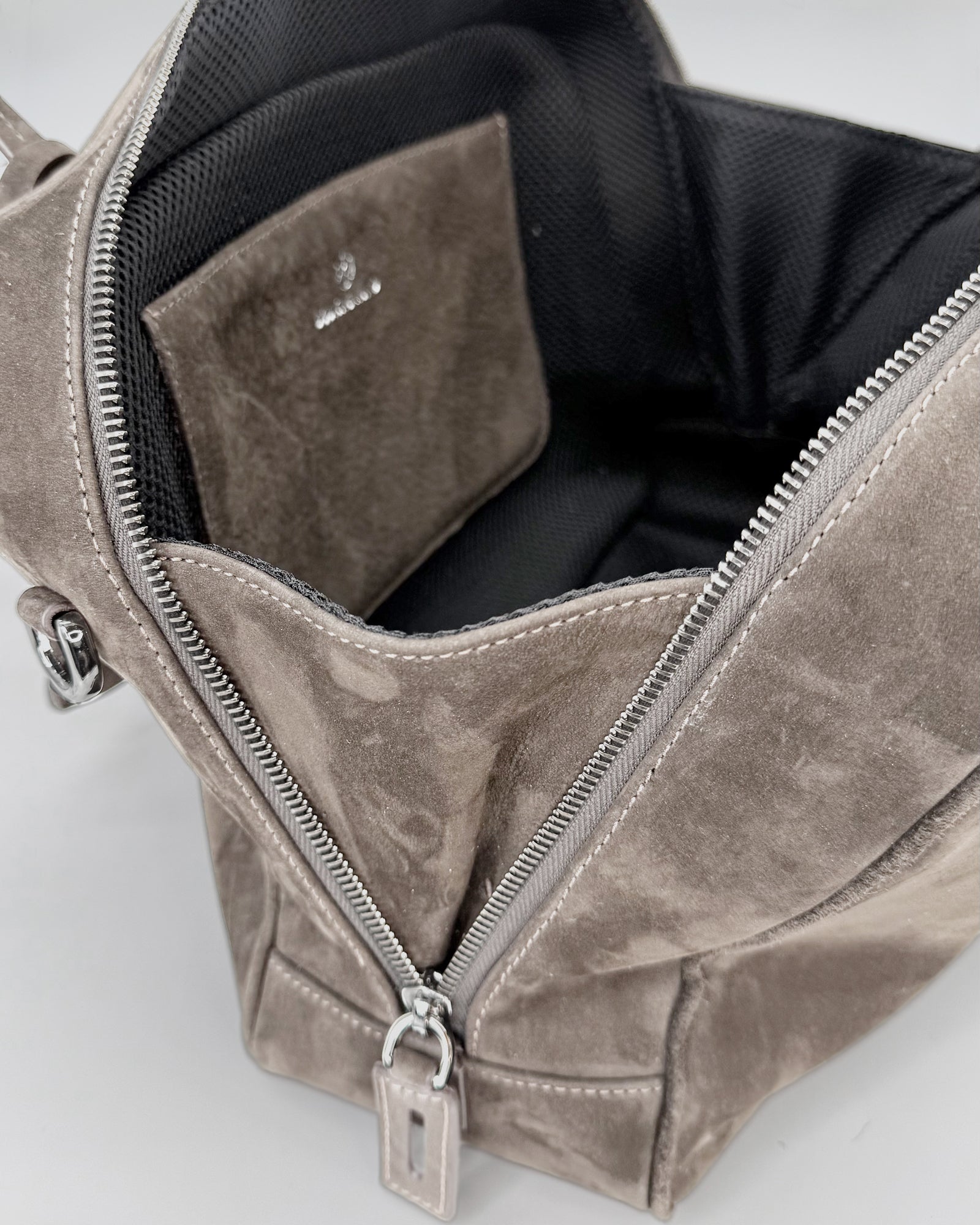 Interior view of the FRIDA Medium Nabuk bag showcasing its soft texture and organized compartments.