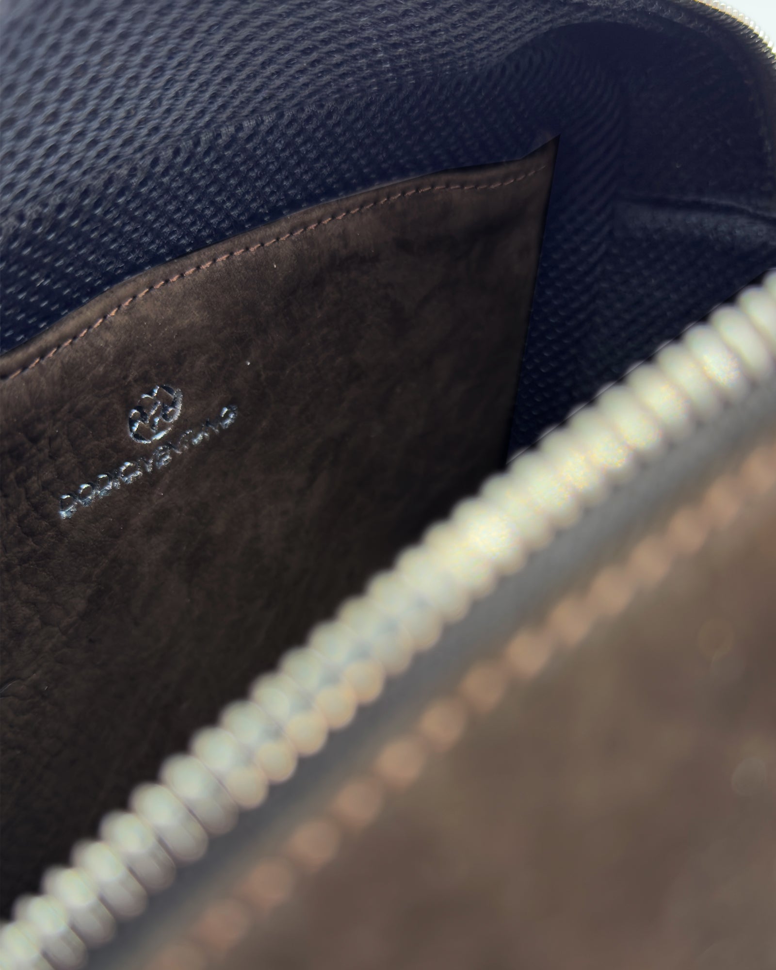 Interior view of the Frida Small Nabuk bag featuring soft nubuck leather and signature logo detailing.