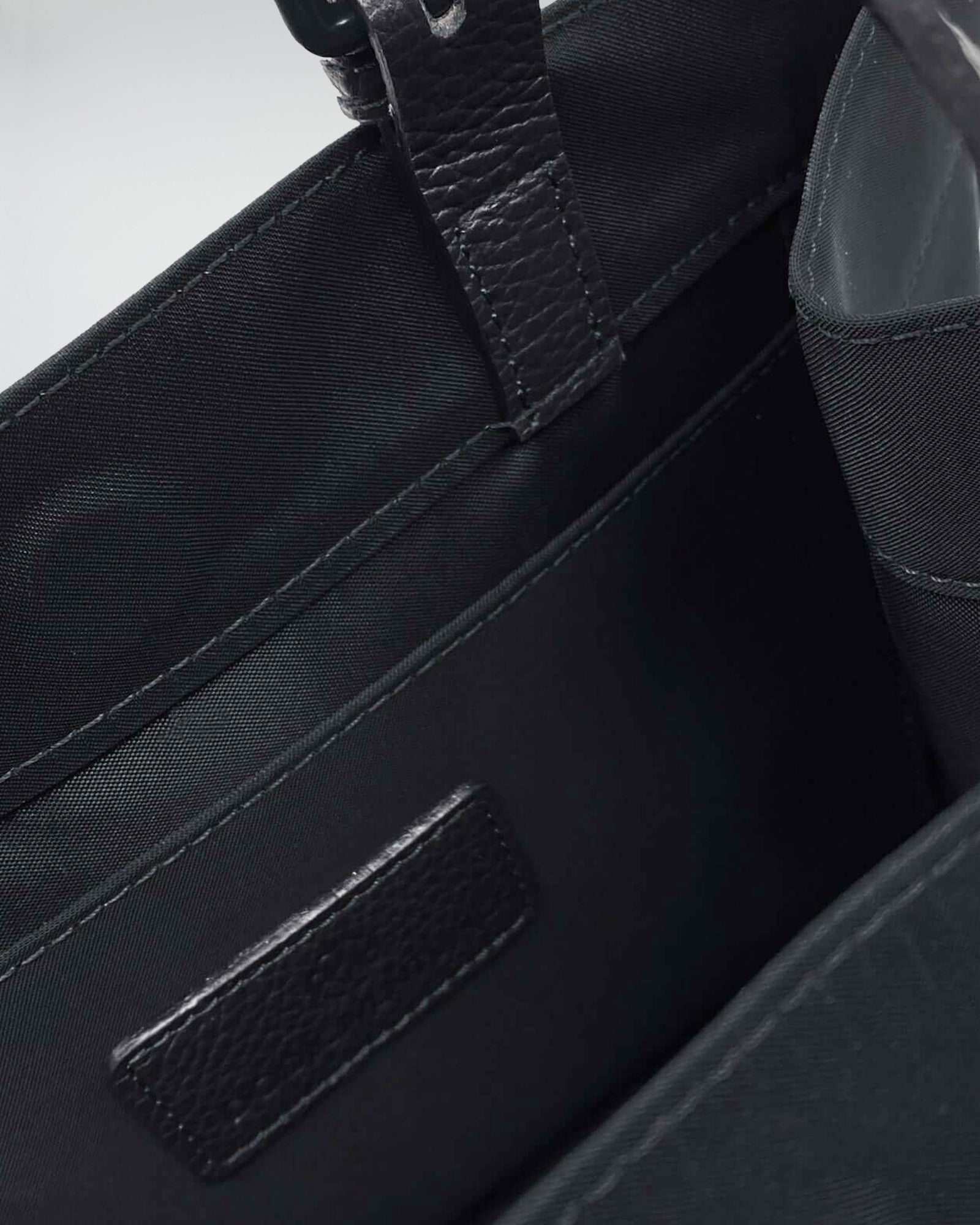 Interior view of the LUDOVICA MINI TESSUTO TECNICO bag showcasing its pockets and lining.