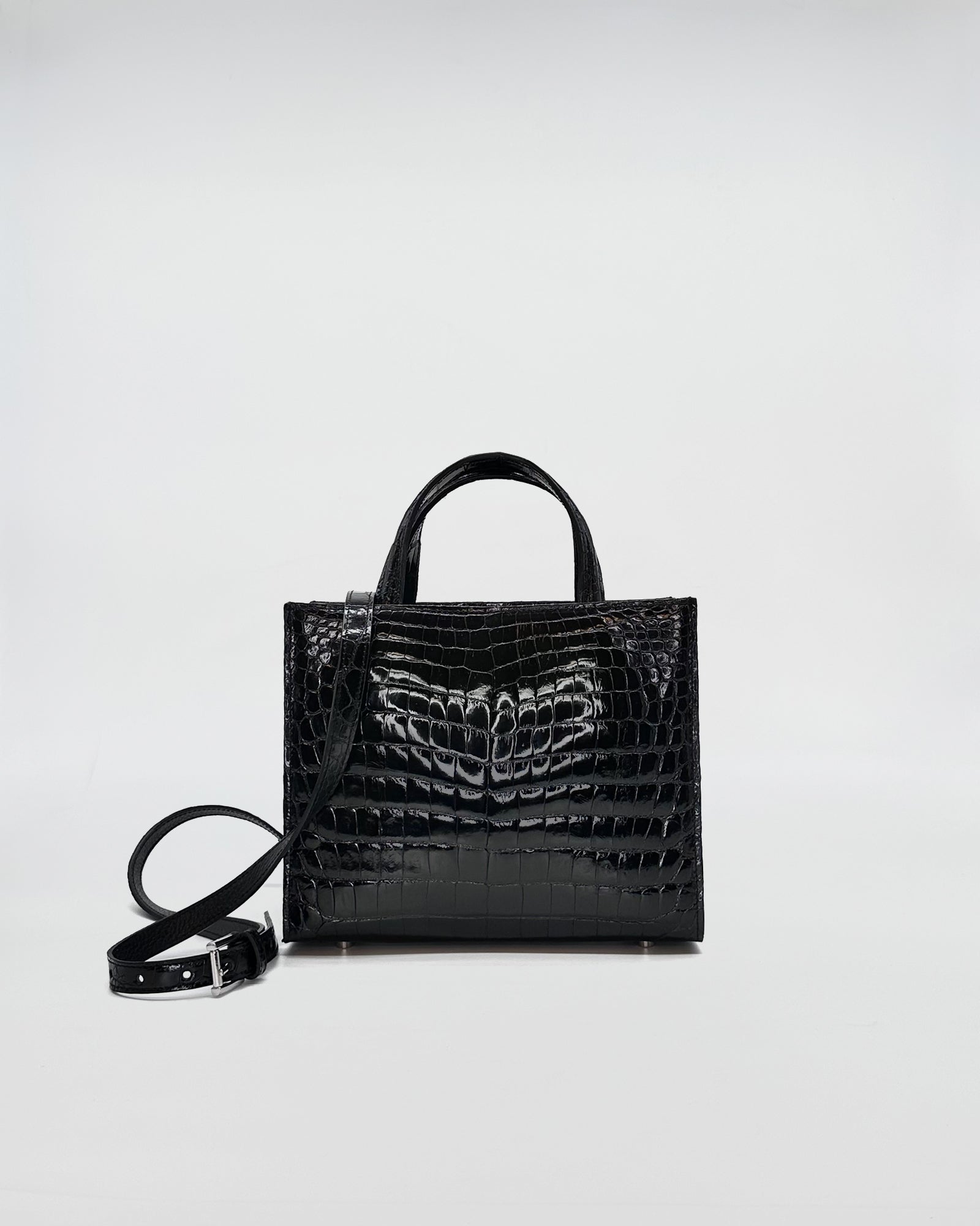 Black coccodrillo recycle handbag with dual handles and crossbody strap, showcasing sleek design and elegant finish.
