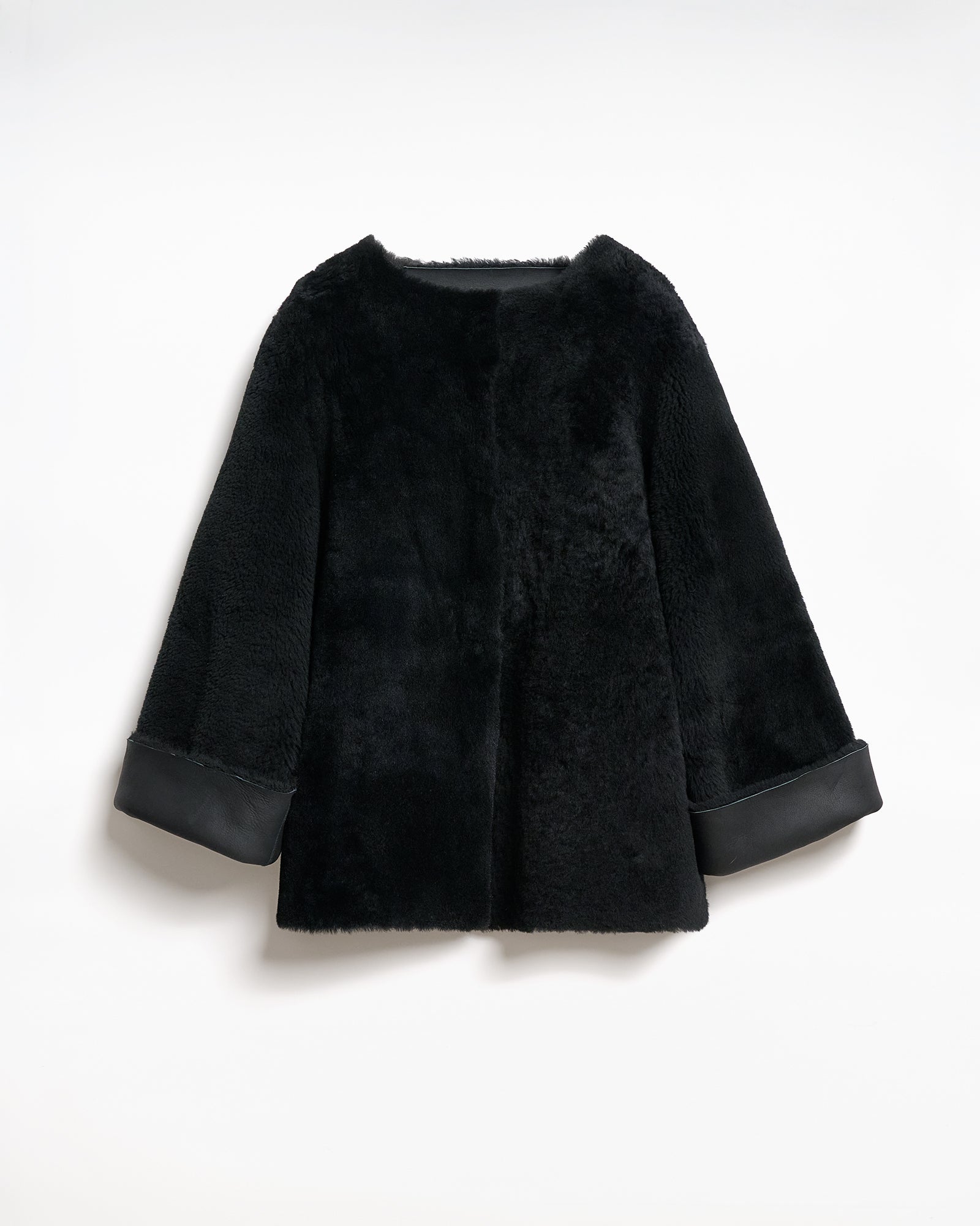 Reversible black montone caban jacket with a relaxed fit and V-neck sleeves.