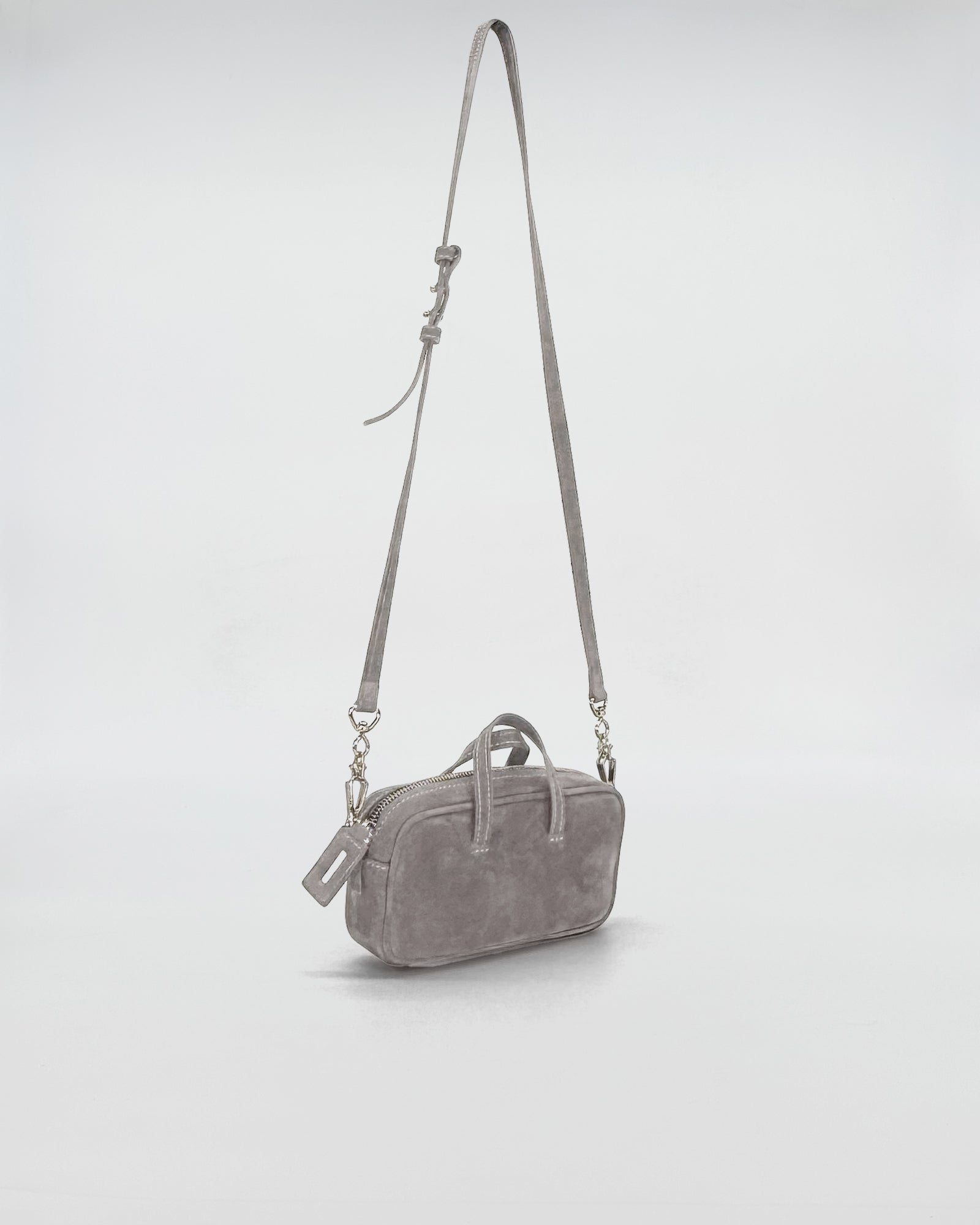 Compact Nina Medium nabuk bag with chain handle, showcasing a refined gray design.