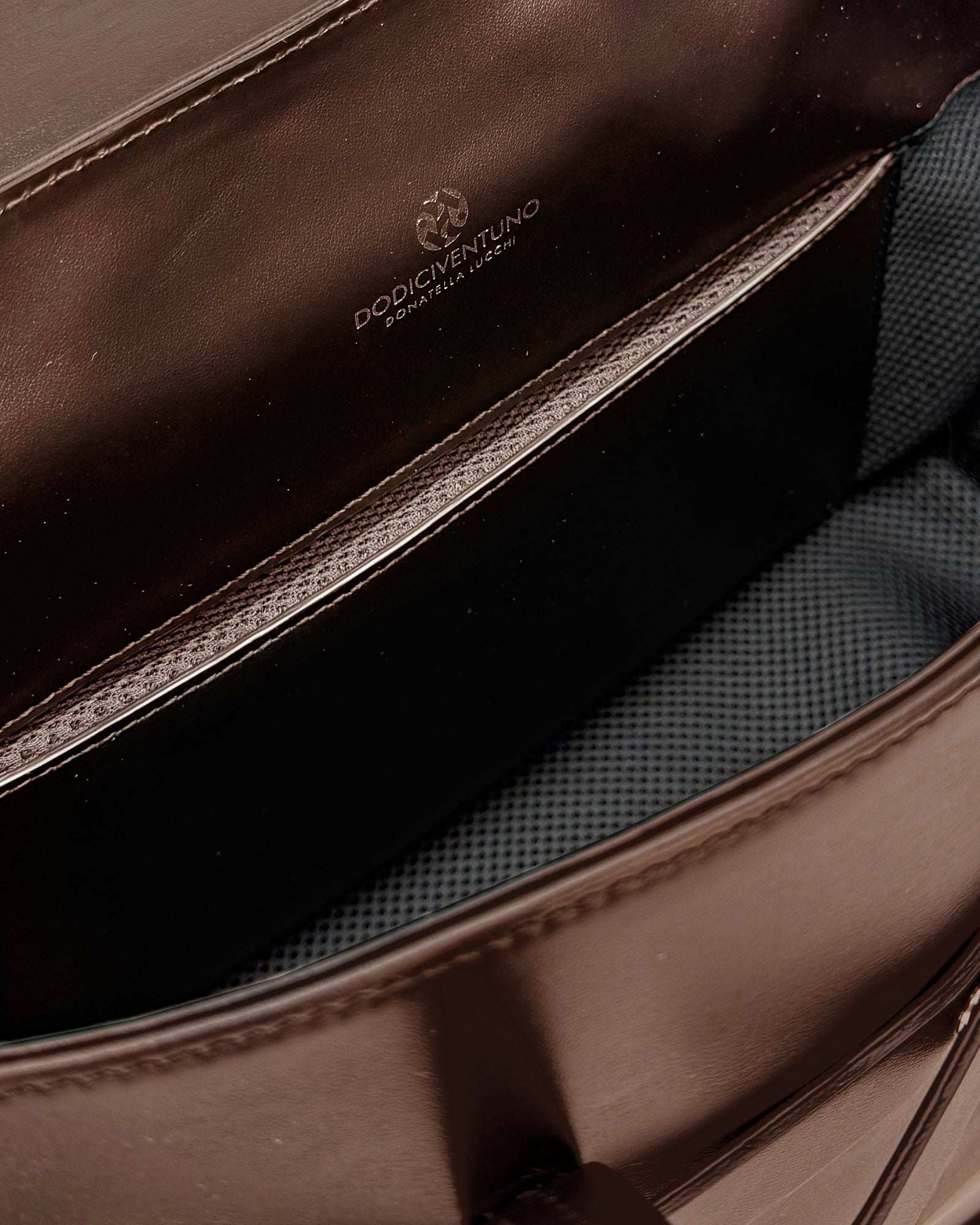 Interior view of the Penny Small Vitello bag, showcasing its spacious design and sleek, luxurious lining.