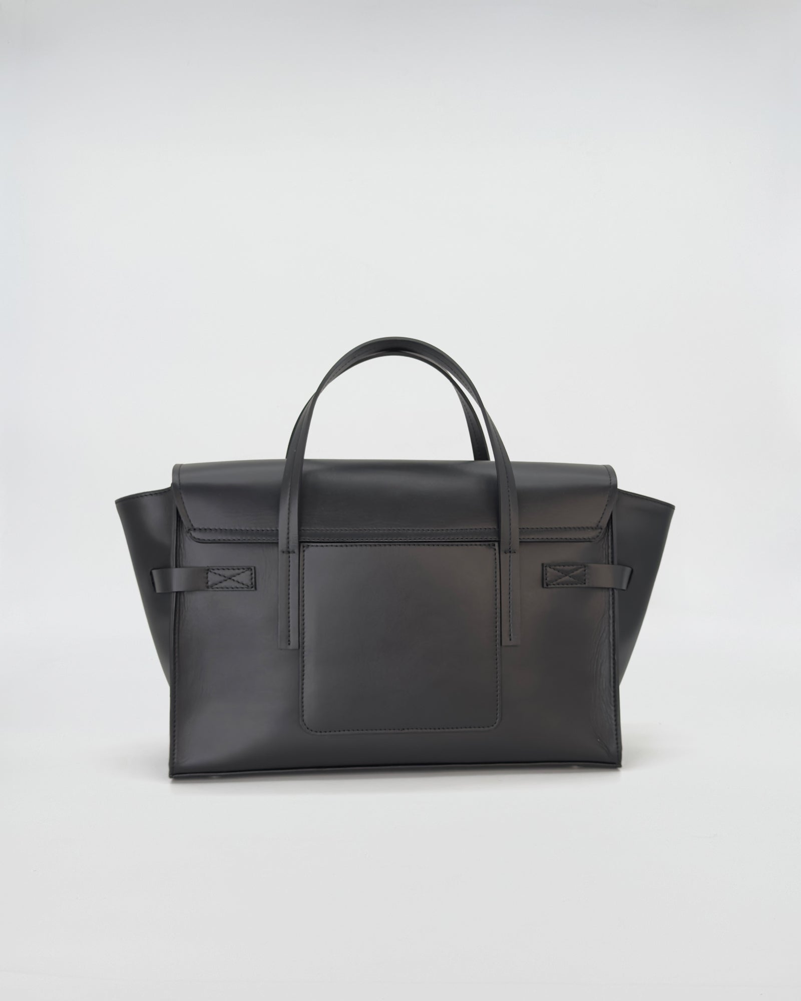 Elegant Penny Medium Vitello bag in smooth black leather with structured design and refined handles.