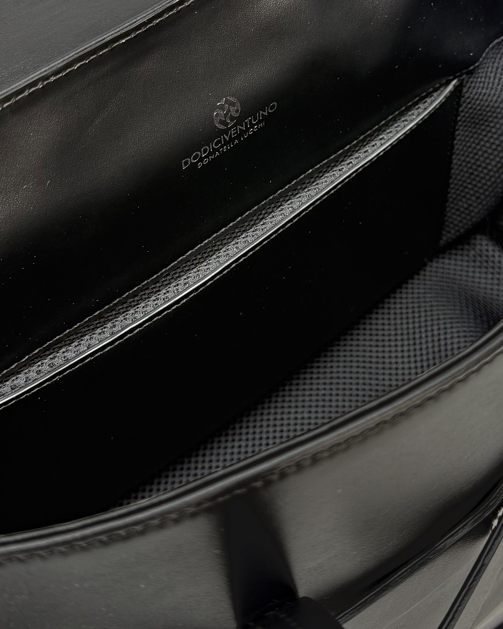 Interior view of Penny Medium Vitello bag showing smooth leather finish and spacious compartments.