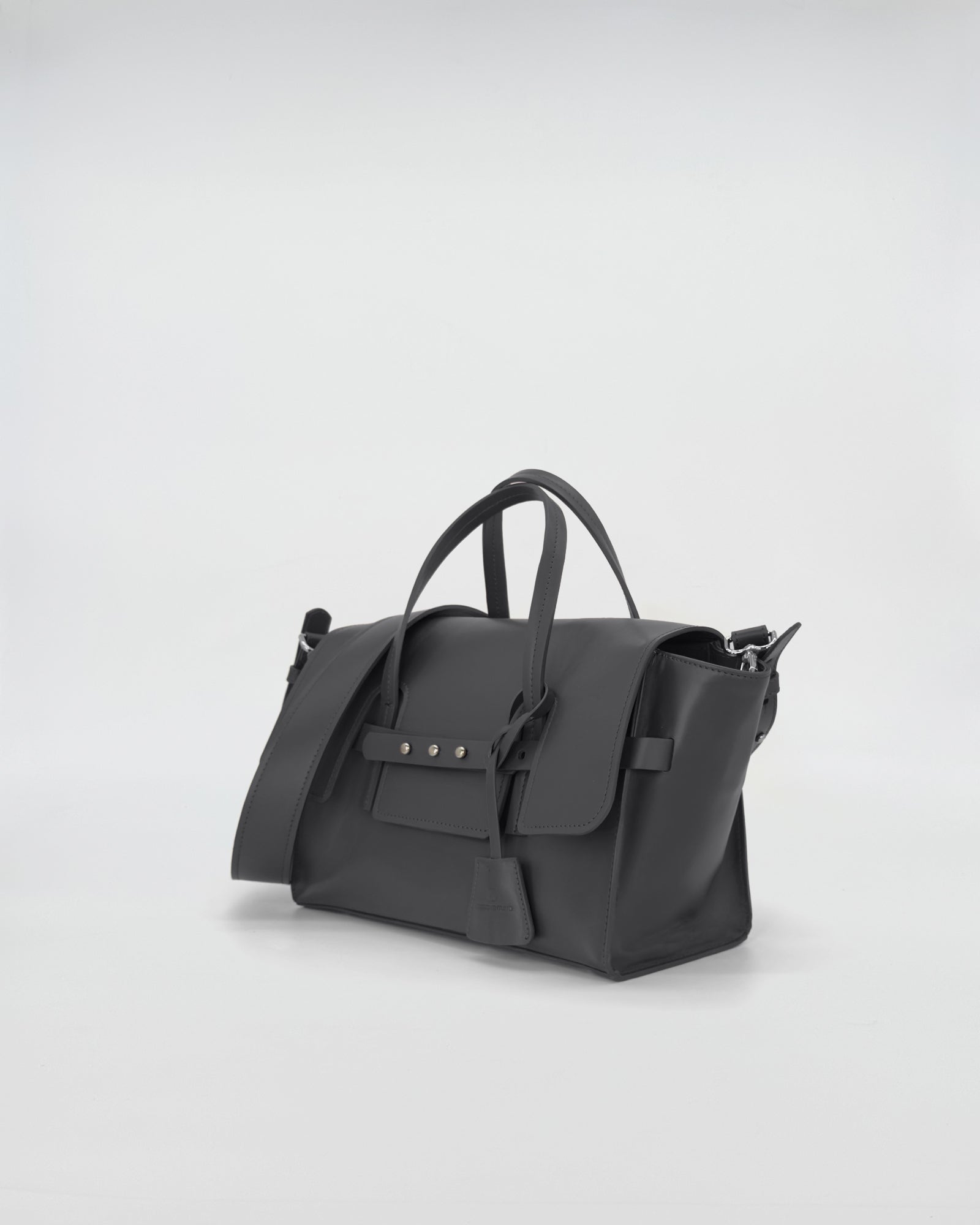 Elegant black vitello handbag with versatile design and refined strap, perfect for any occasion.