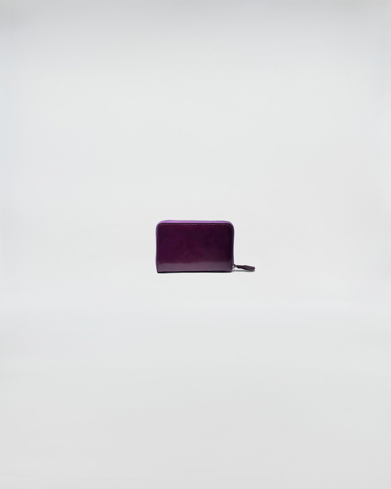 PORTAFOGLIO ZIP MINI in purple leather with zip closure, featuring a sleek and sophisticated design.