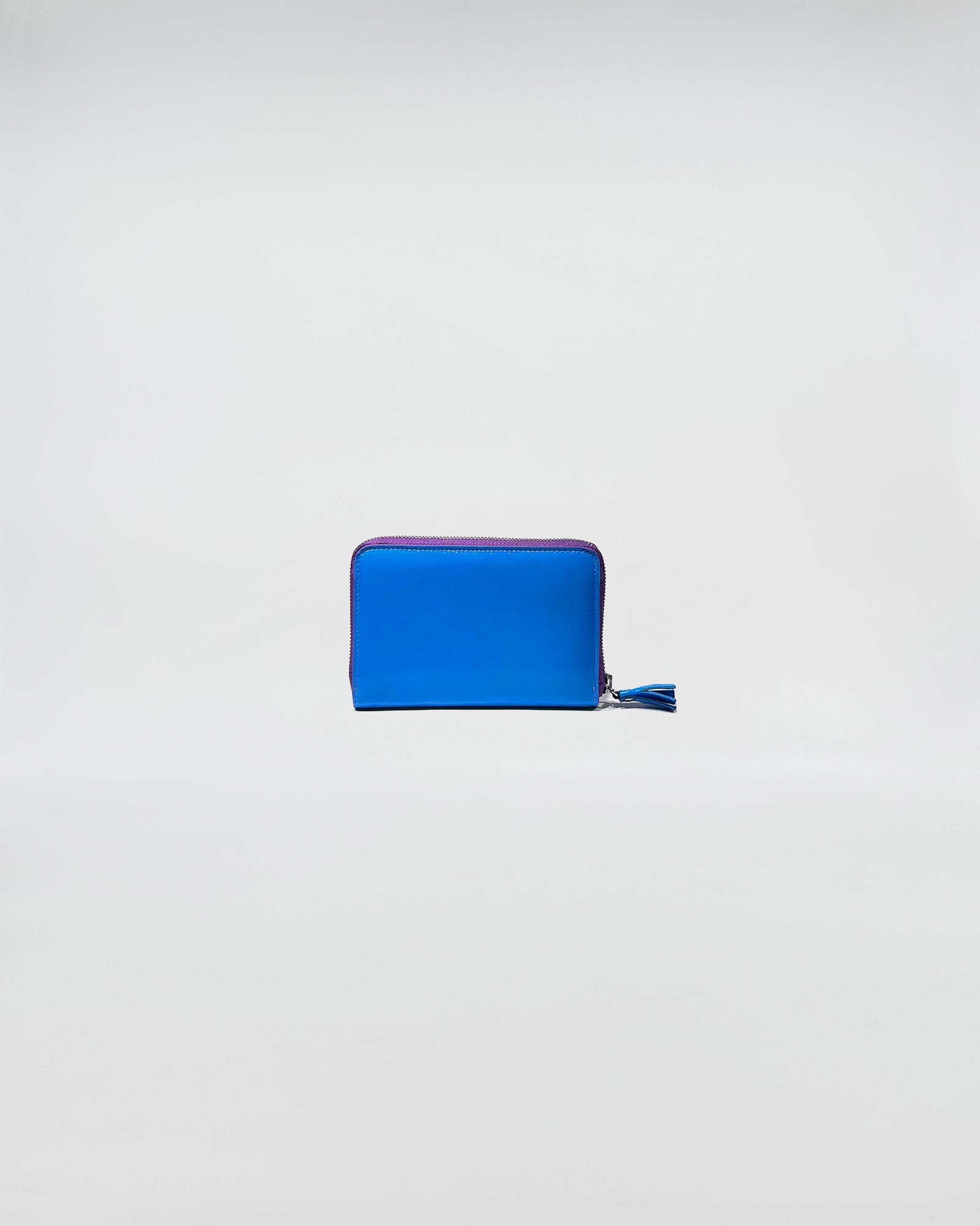 Portafoglio Zip Small in blu con chiusura zip e dettagli in viola, accessorio elegante per uso quotidiano.