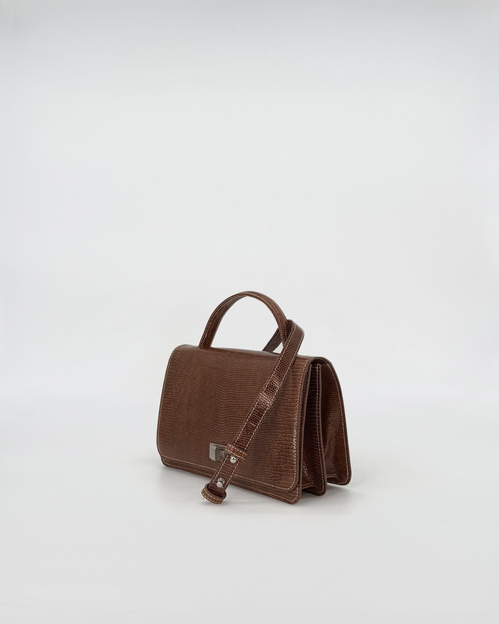 Elegant brown Queen Tejus recycle handbag with smooth suede interior and practical metal closure.