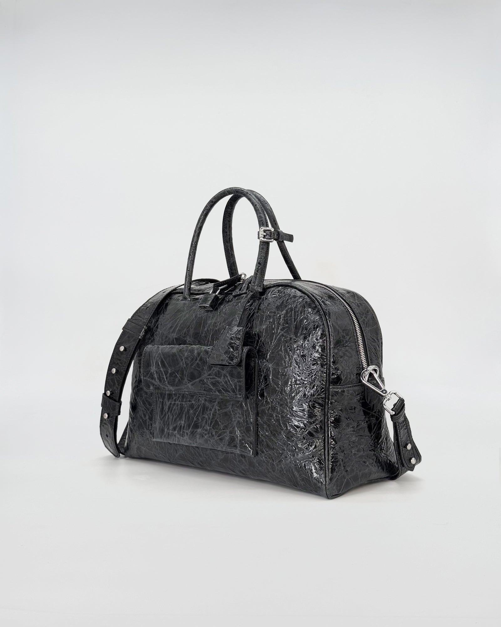 Zoe Medium Vitello Strizzato bag in black, showcasing elegant curves and a modern design.