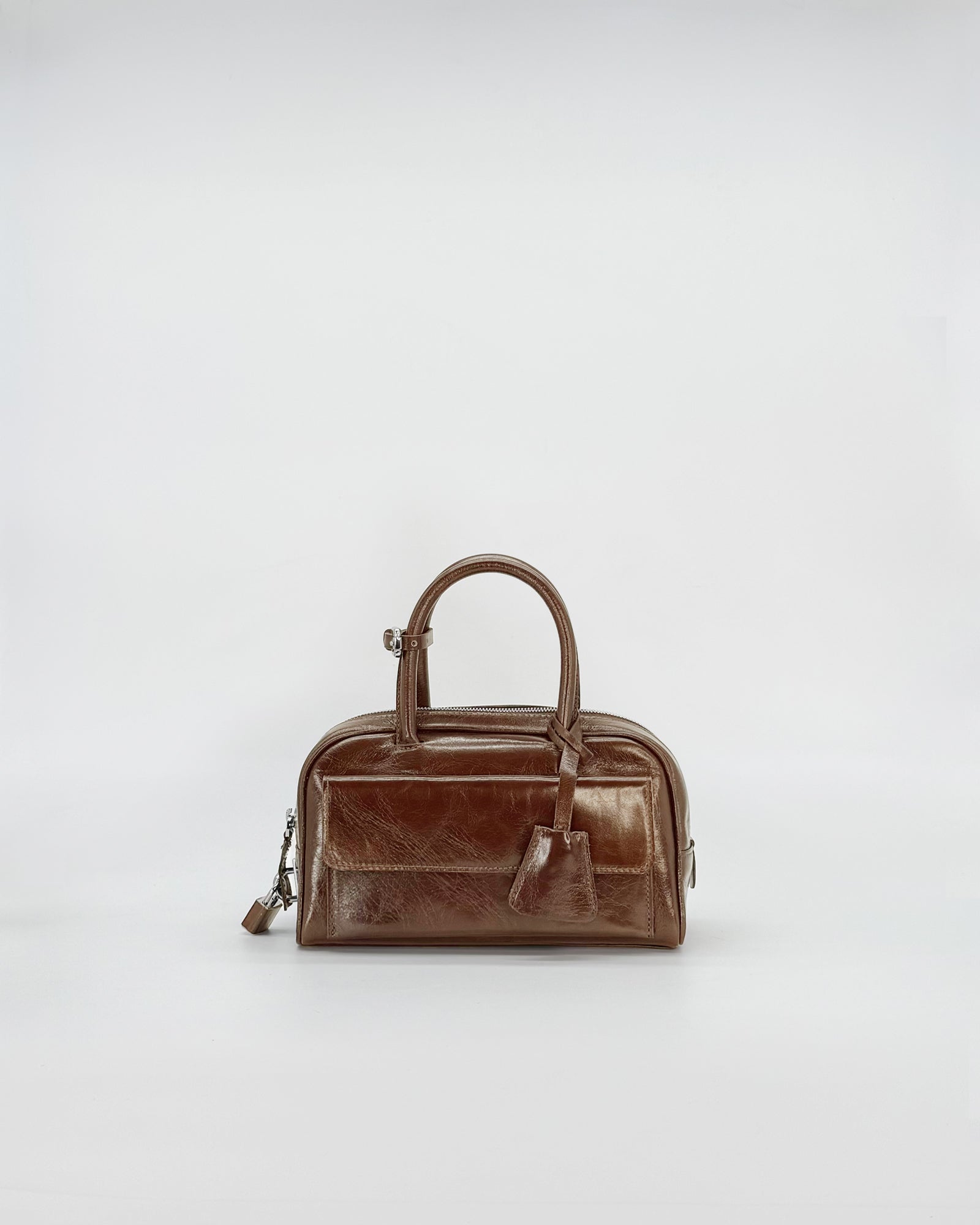 Zoe Mini Vitello Semilucido handbag in elegant brown finish, showcasing compact design for stylish outings.