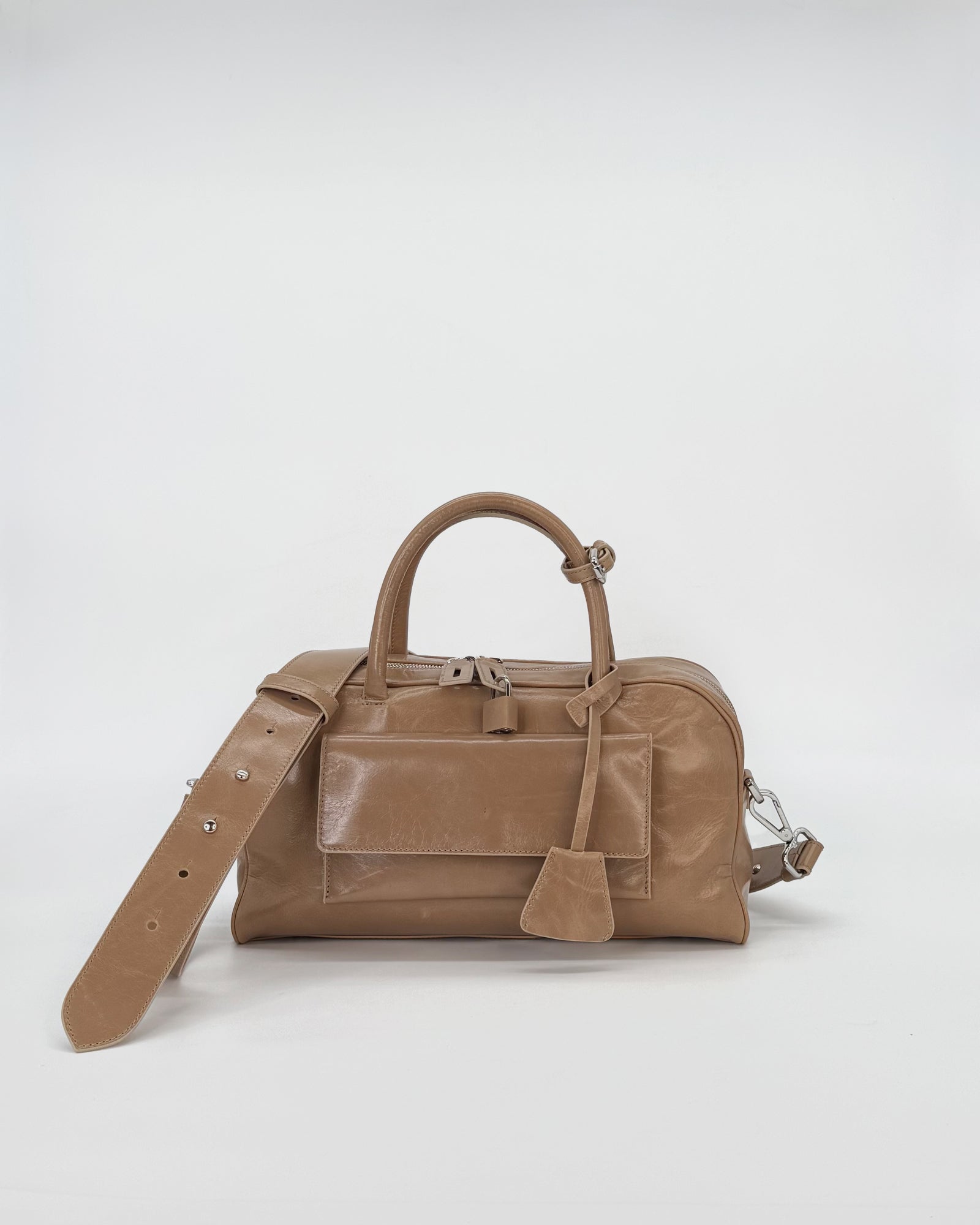 Small vitello semilucido bag in tan with a structured design and adjustable strap.