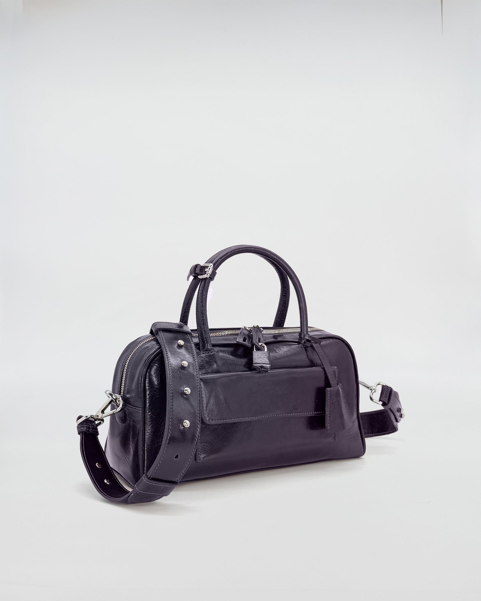 Small black Vitello Semilucido Zoe bag with sleek design and detachable strap, perfect for everyday use.