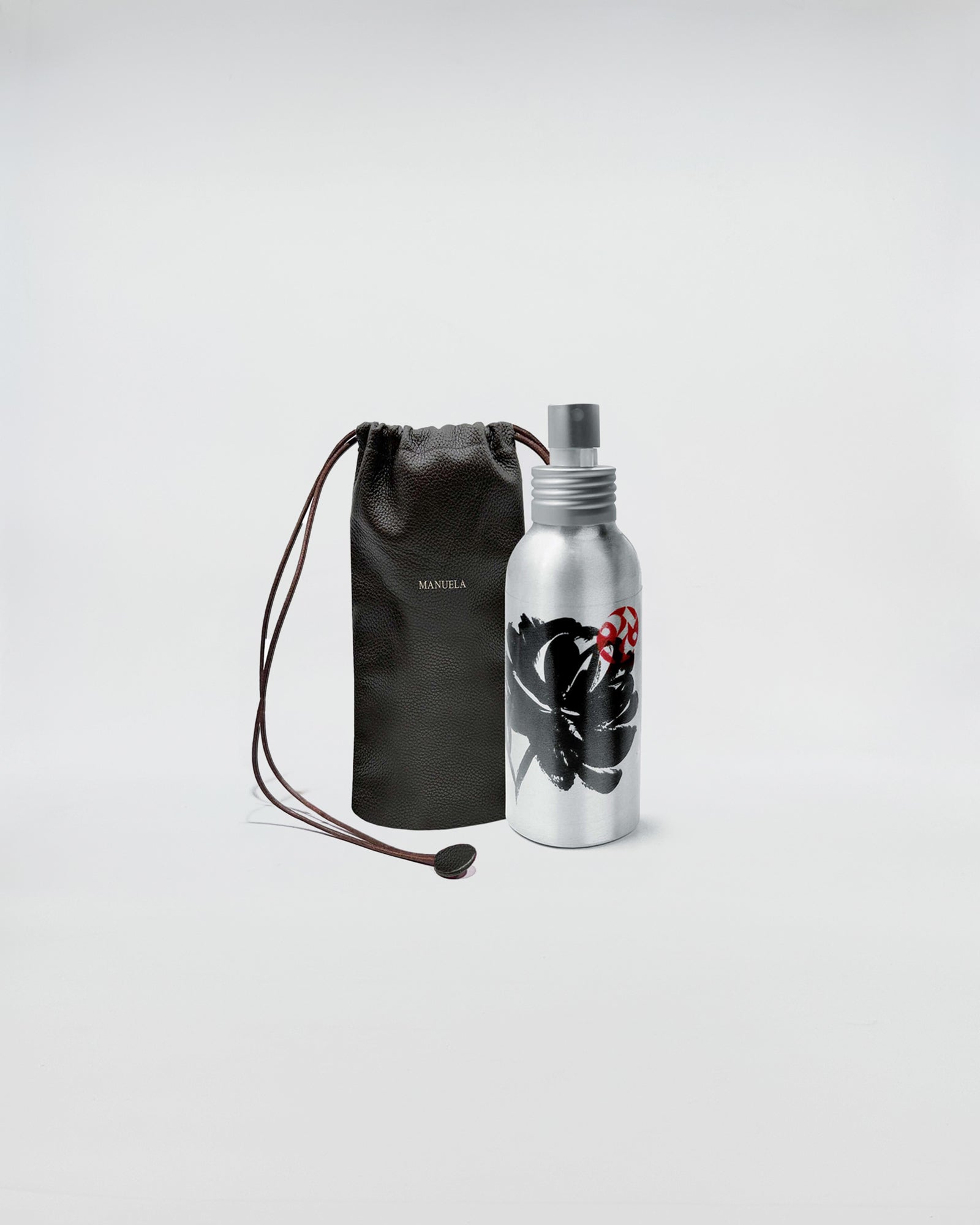 1221 EAU DE PARFUM in silver bottle with floral design and black pouch for storage.