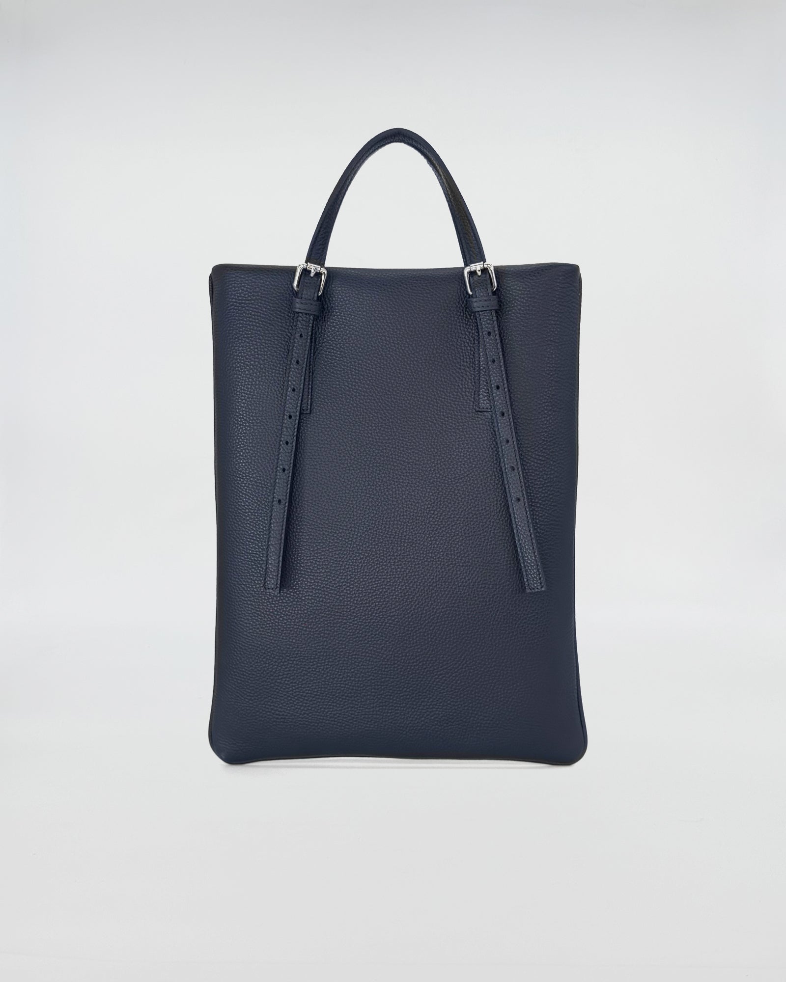 AMELIE PORTACOMPUTER versatile computer bag in dark navy leather with adjustable handles.