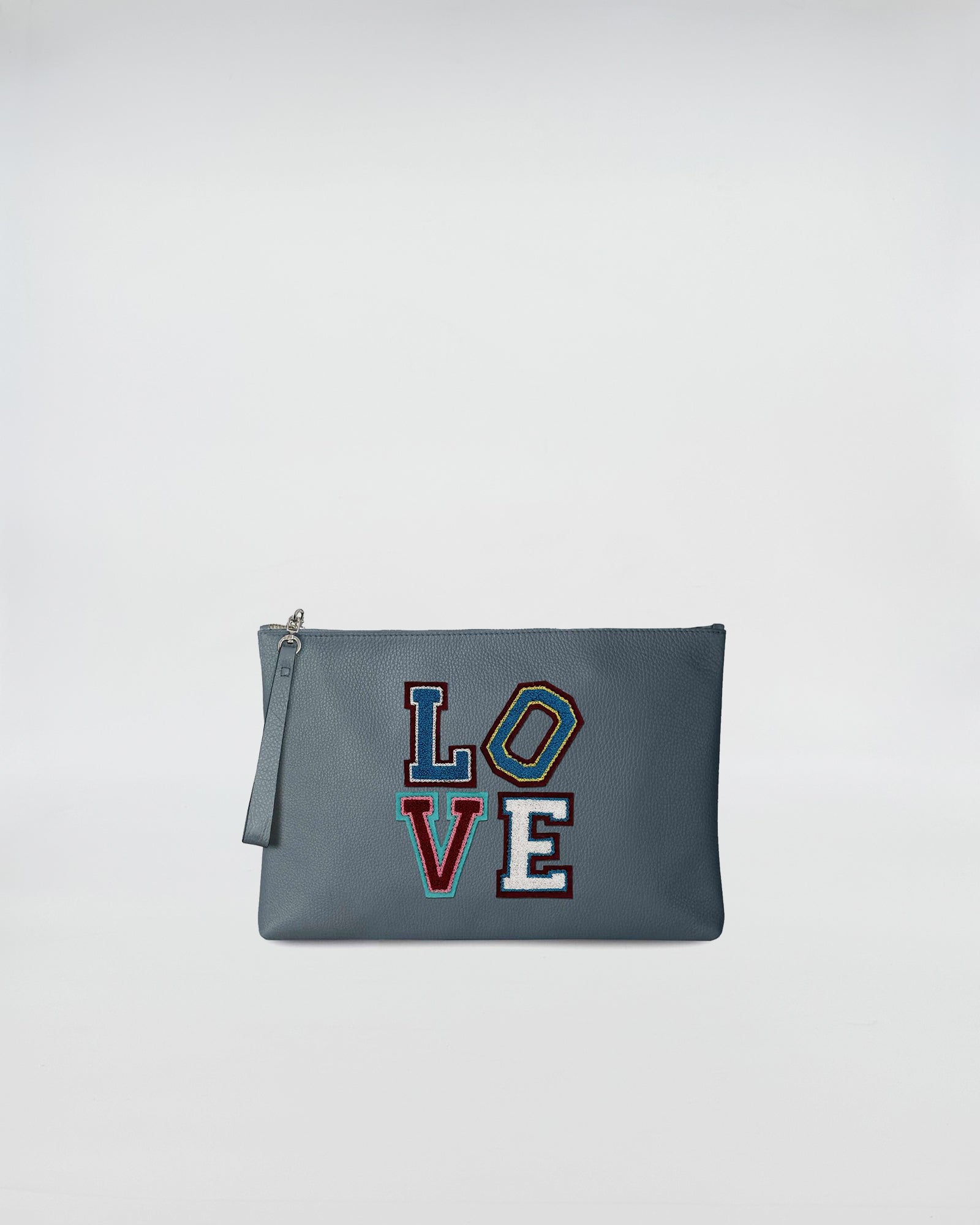 BUSTA A4 LOVE in blue leather with colorful LOVE patch and zip closure, perfect for those who appreciate irony and practicality.