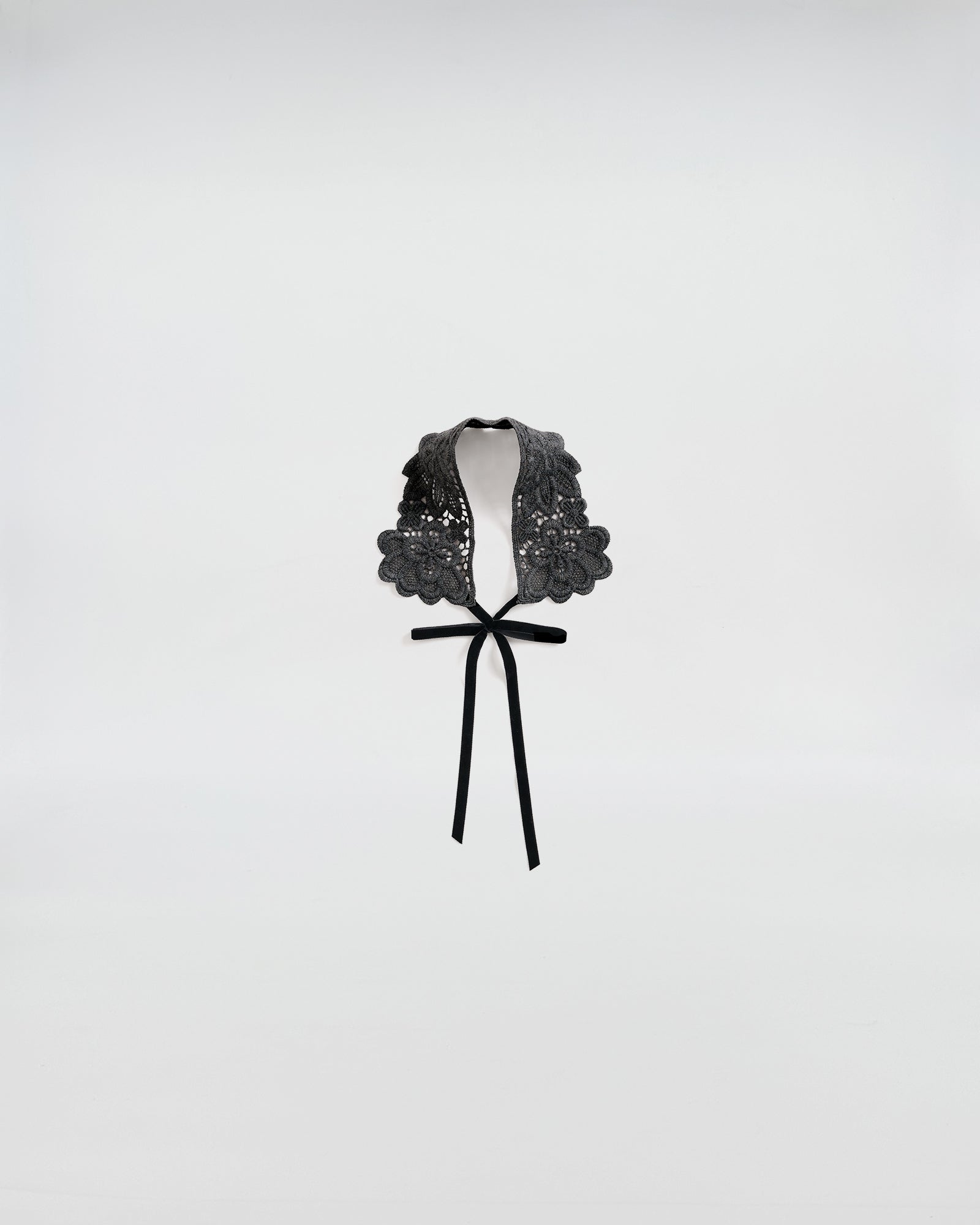 Black macramé lace collar with bow, adding a touch of elegance and femininity to any outfit.