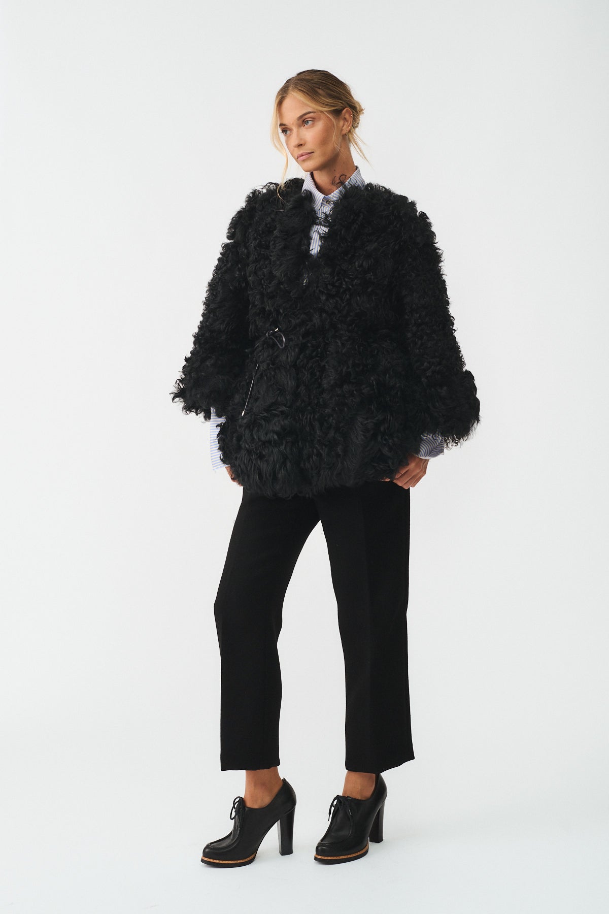 Woman wearing a stylish black caban in Kalgan upcycle, combining classic elegance with contemporary design.