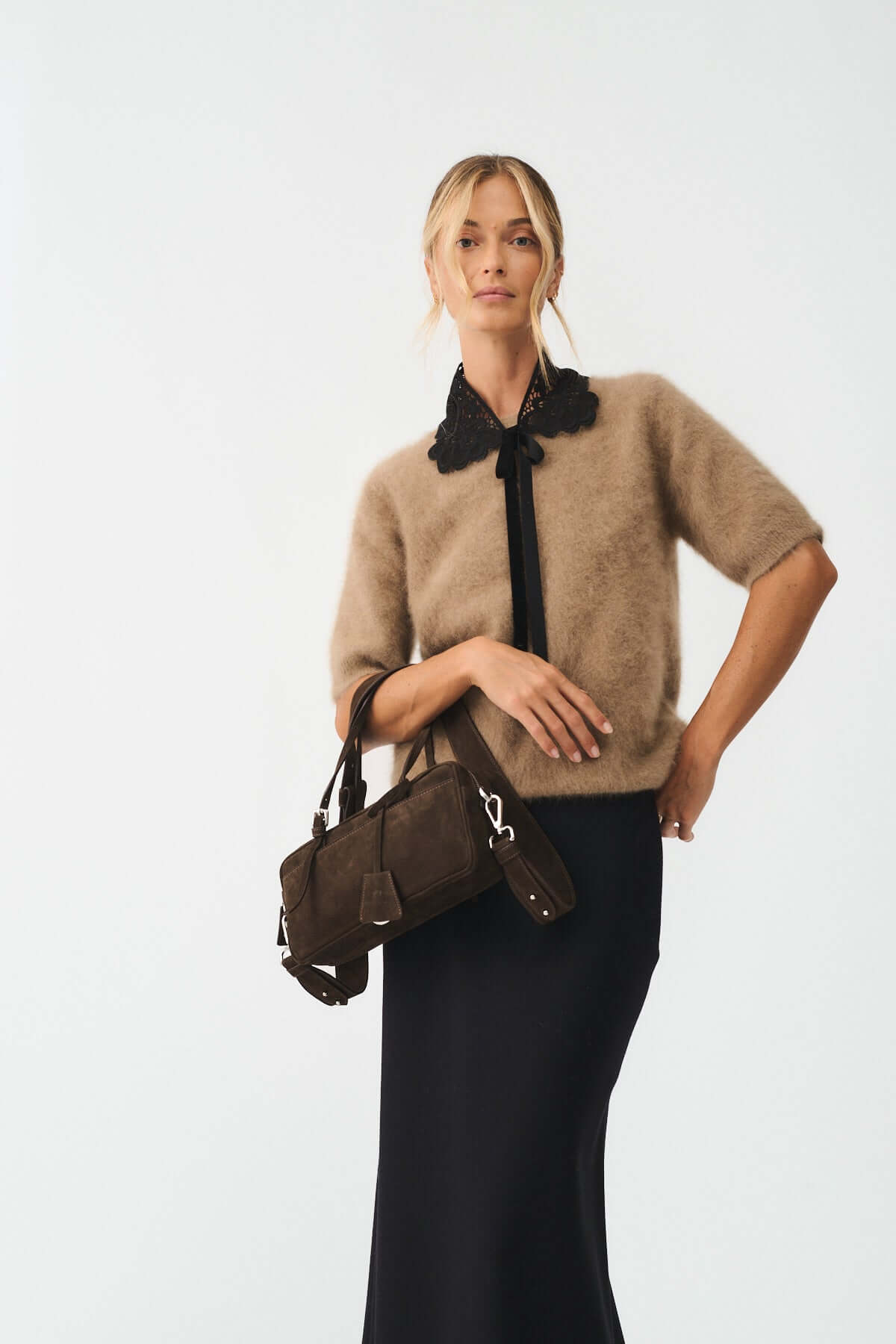 Model showcasing ASIA NABUK handbag, styled with a cozy sweater and long skirt, emphasizing versatility and elegance.