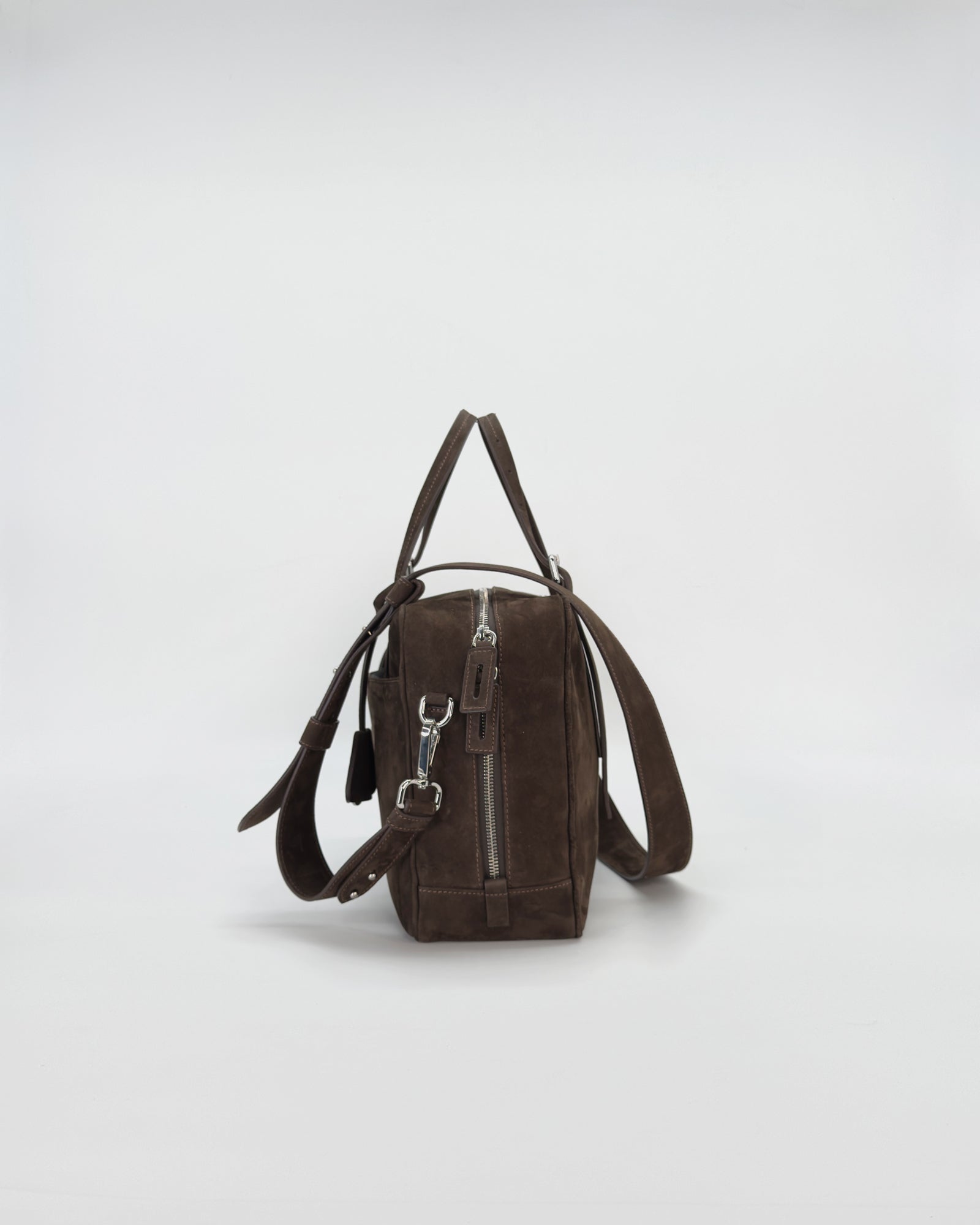 Elegant brown nabuk handbag 'Frida' with modern design and retro charm, showcasing smooth texture and stylish straps.