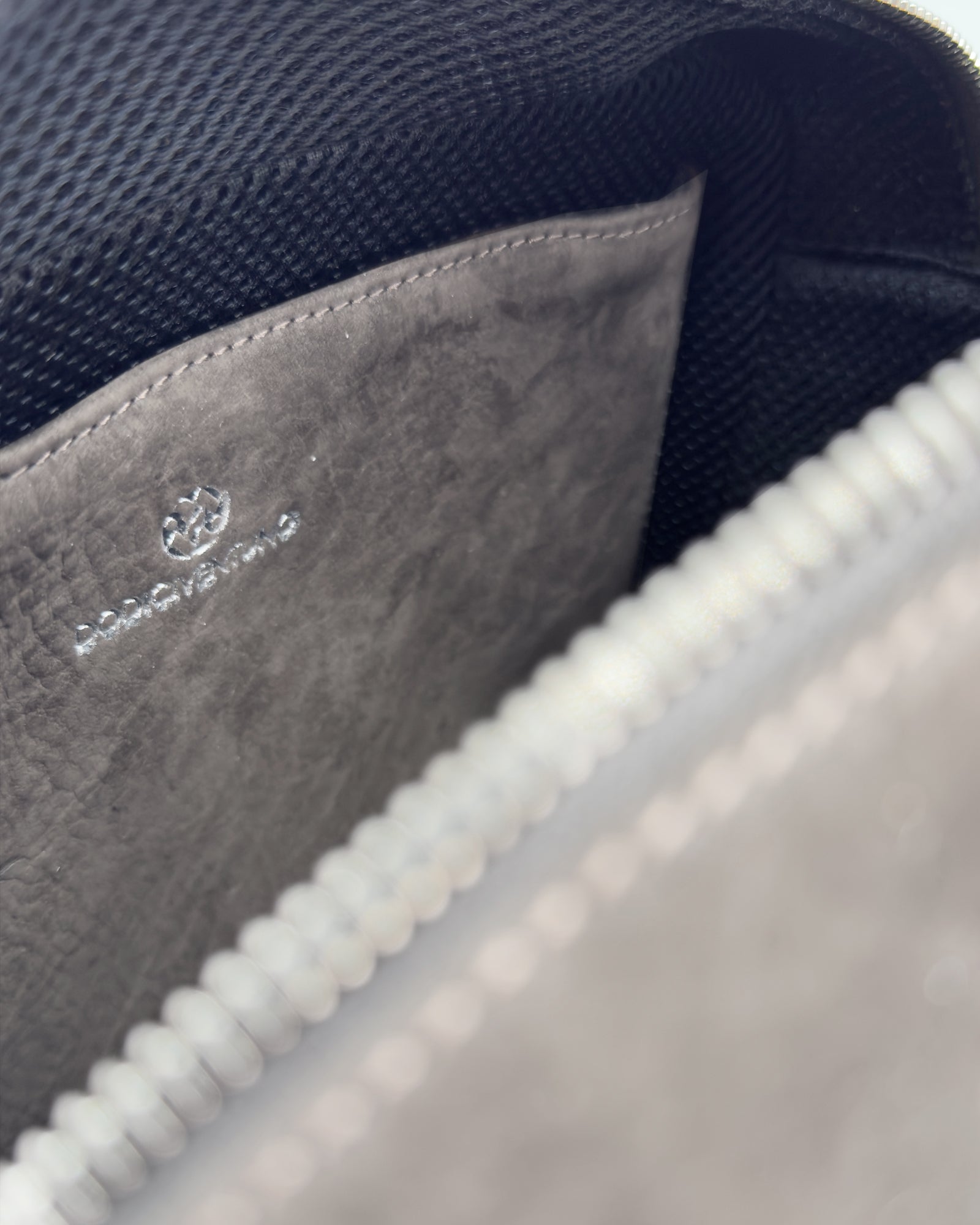 Interior view of the Frida small nabuk bag, showcasing soft nubuck leather and elegant design.