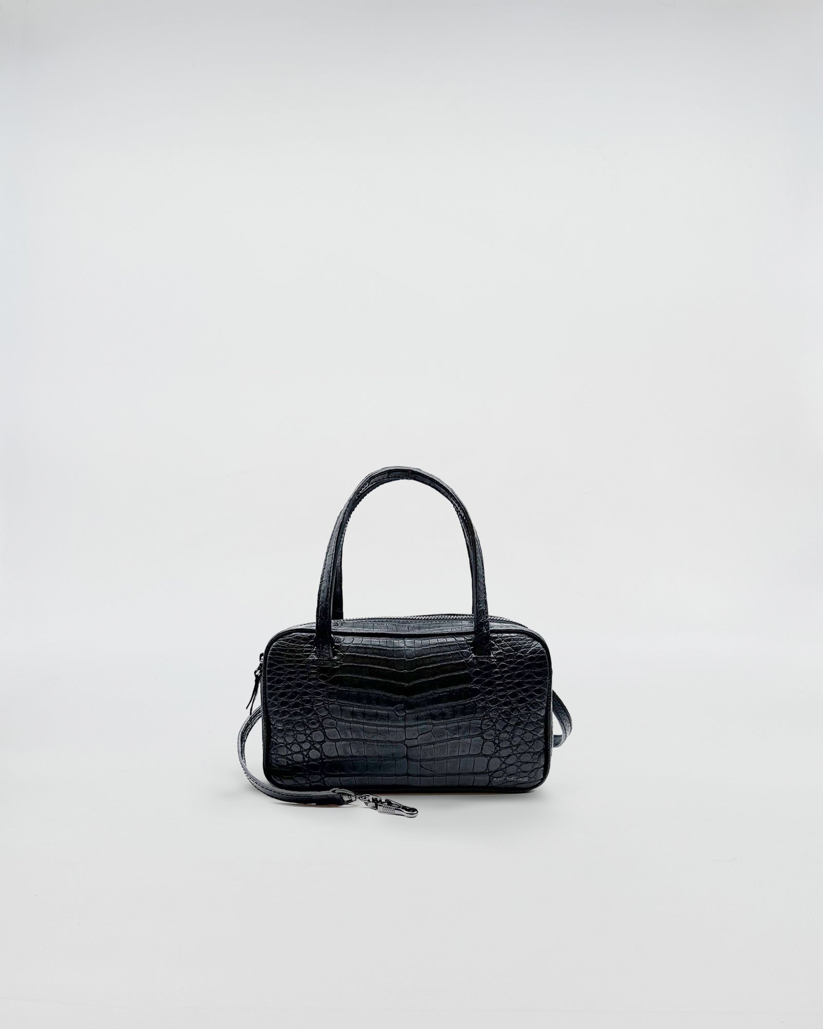 GINEVRA COCCO RECYCLE black crocodile leather handbag with elegant design and soft suede interior.