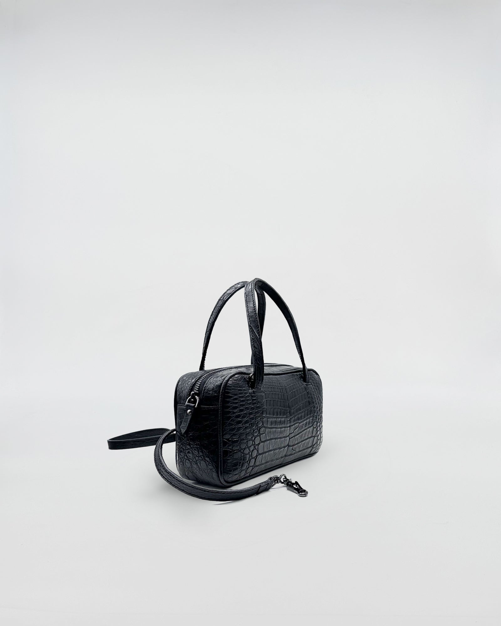 GINEVRA COCCO RECYCLE elegant black recycled crocodile leather handbag with a sophisticated design and soft suede interior.