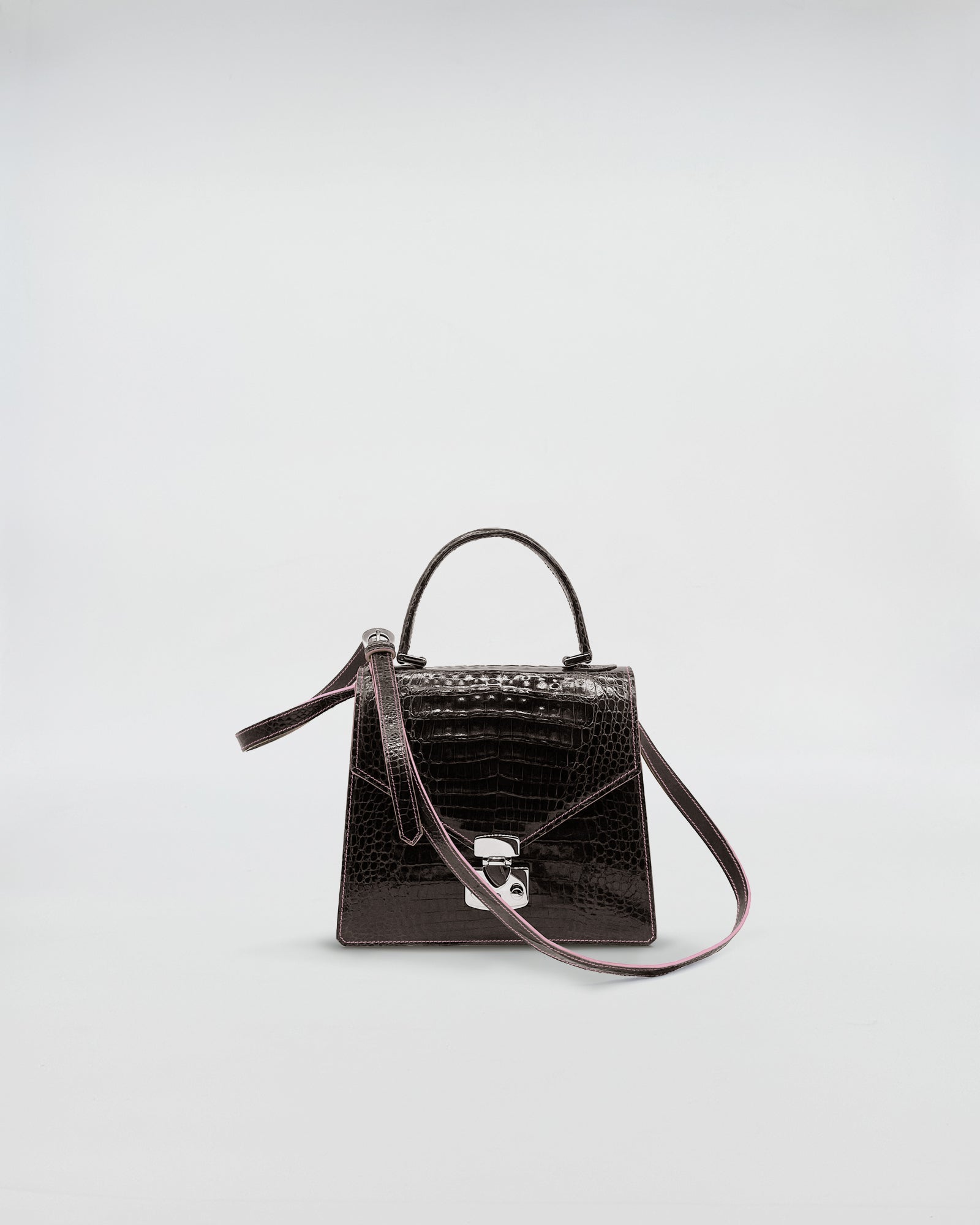 Lady D - COCCO RECYCLE handbag made of recycled crocodile leather, with a suede green interior and adjustable strap.