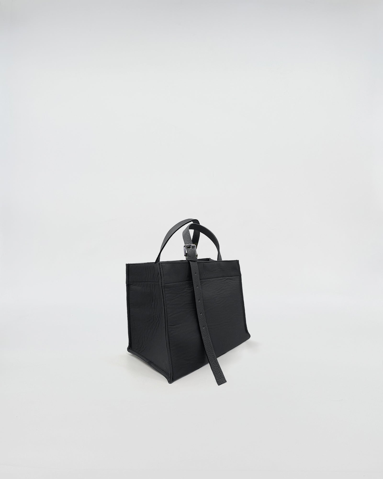 LUDOVICA MINI  TESSUTO TECNICO black handbag with short handles on a light background
