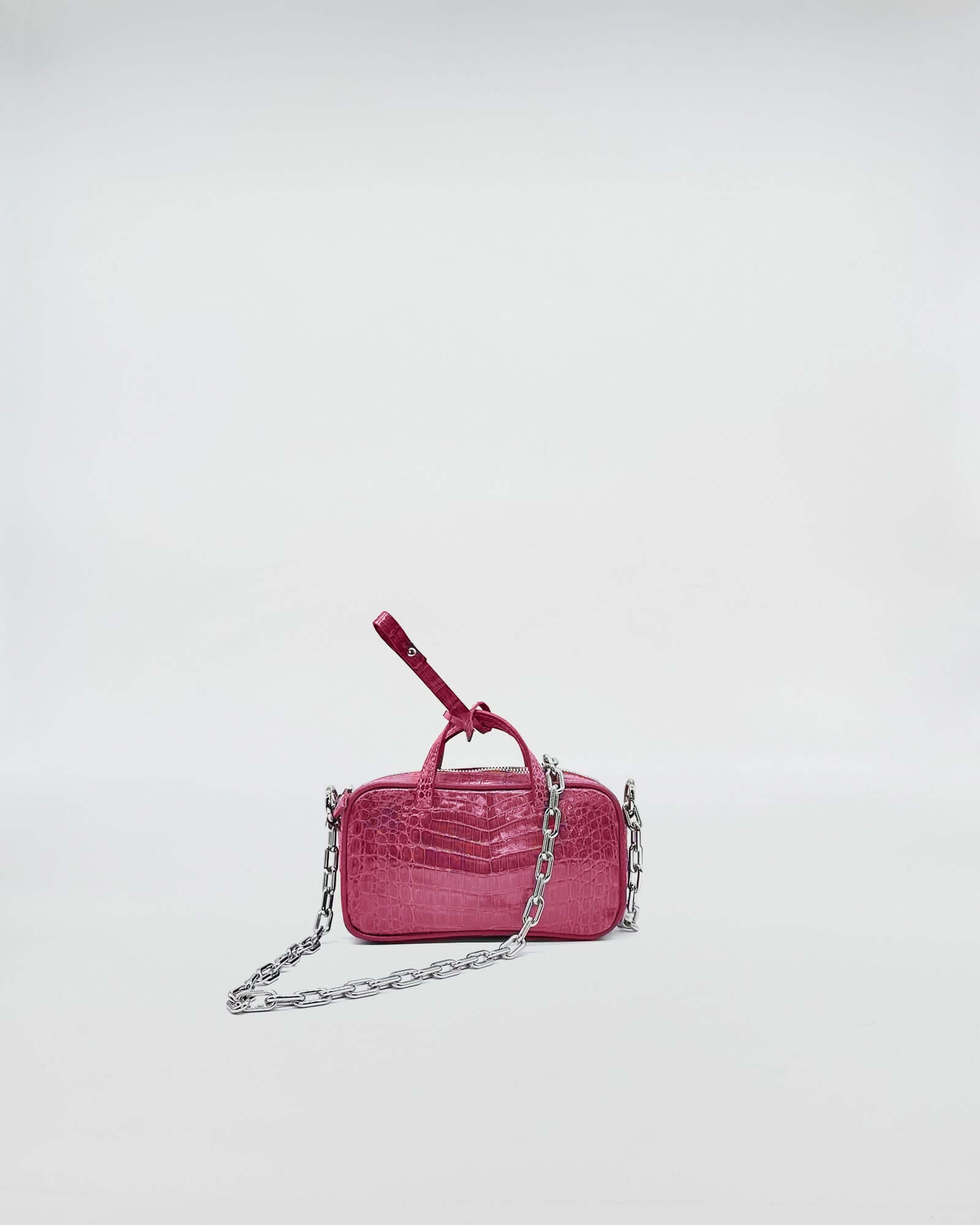 MICRO BAG NINA COLORATA MEDIUM COCCO RECYCLE in pink with metallic chain strap on plain background