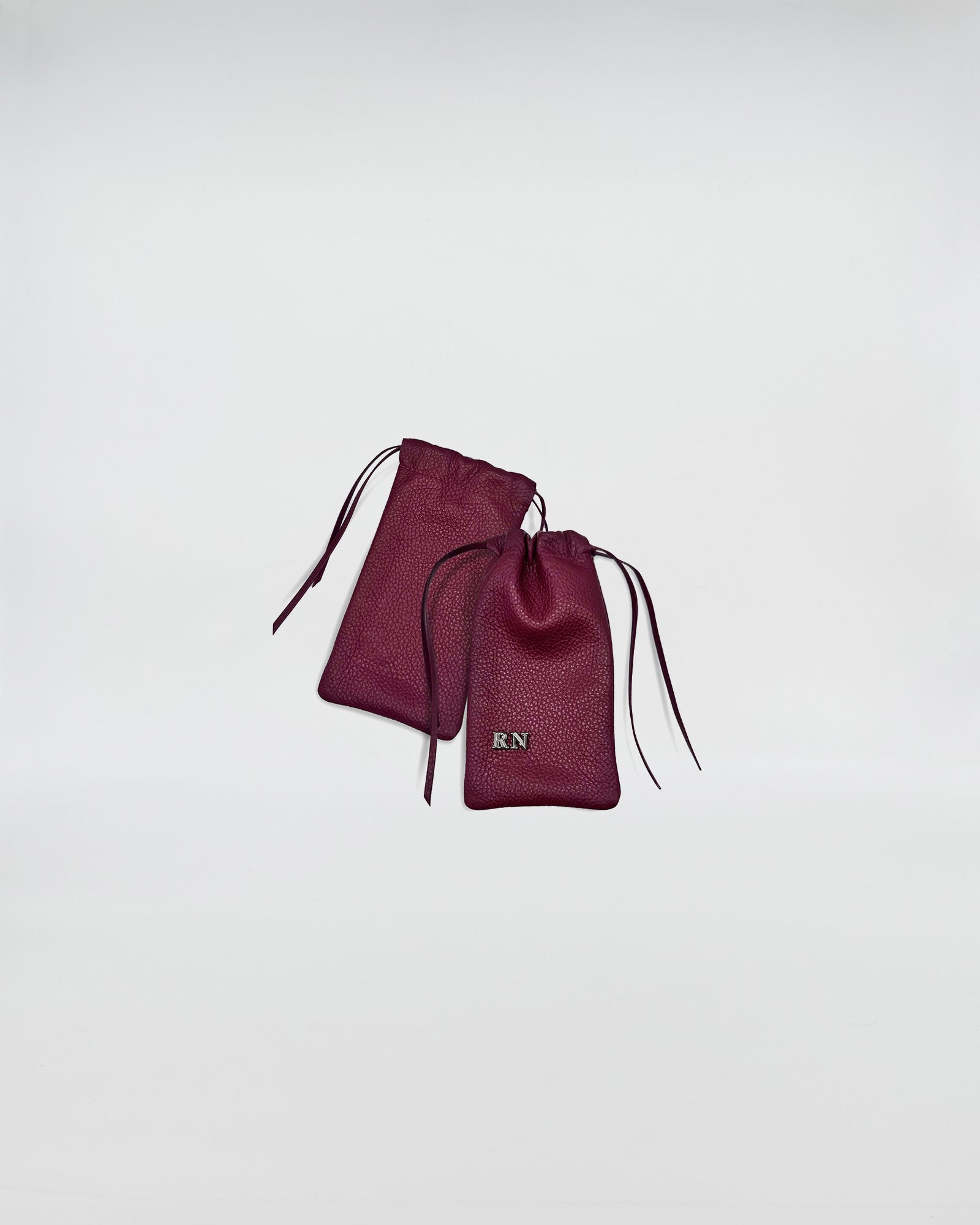 PORTA OCCHIALI LEO in burgundy leather with drawstrings and RN logo on the pouch.