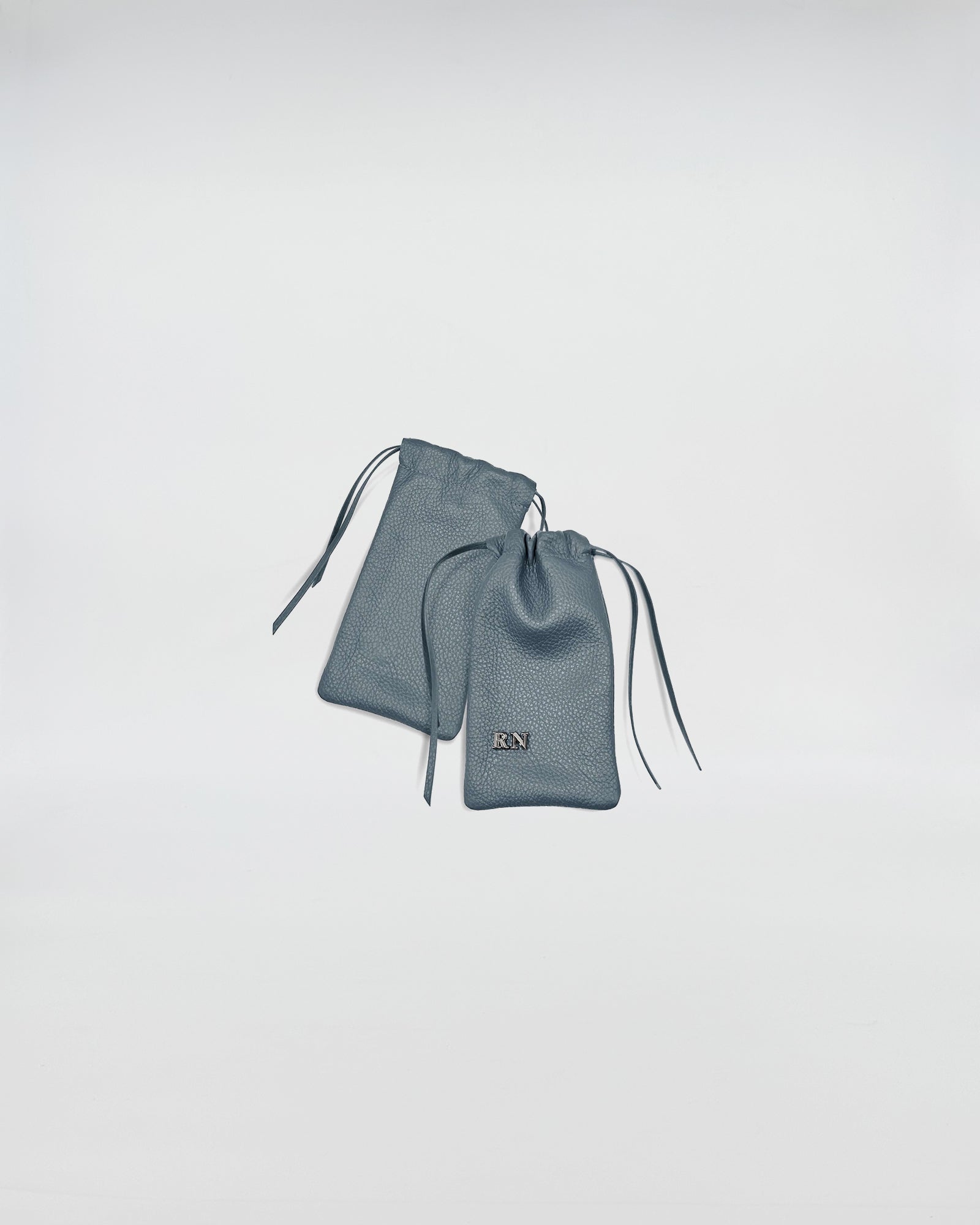 PORTA OCCHIALI LEO blue leather cases with drawstring closure and branded logo.