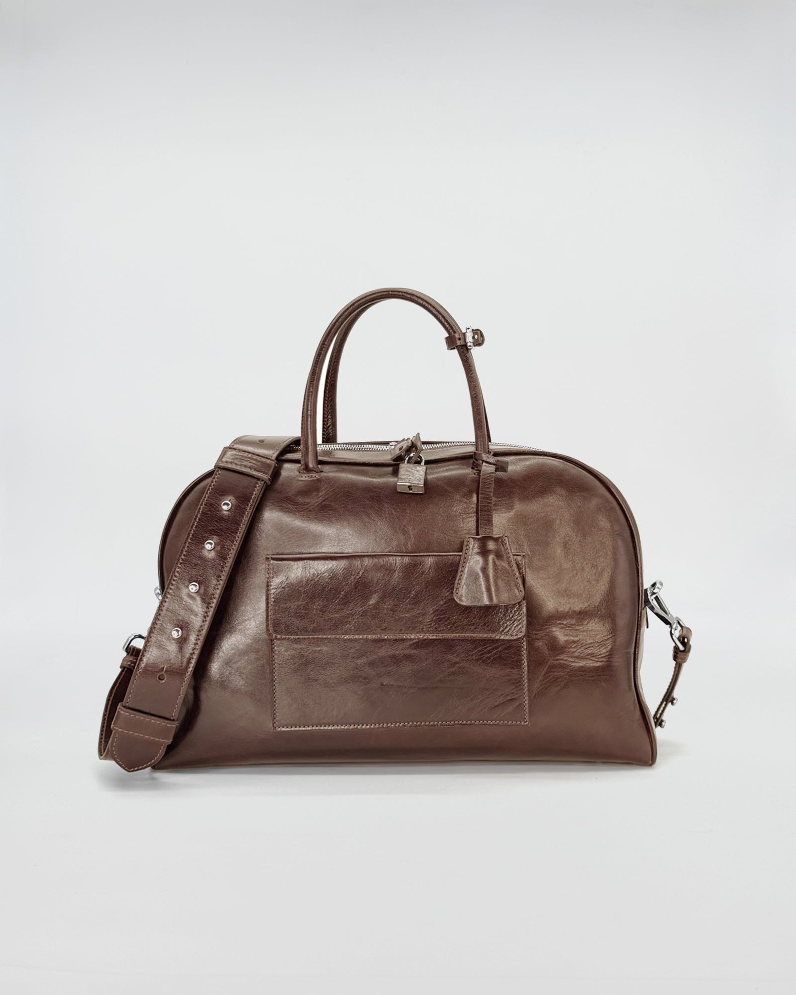 Zoe medium vitello semilucido bag in rich brown leather, showcasing a stylish retro-modern design.