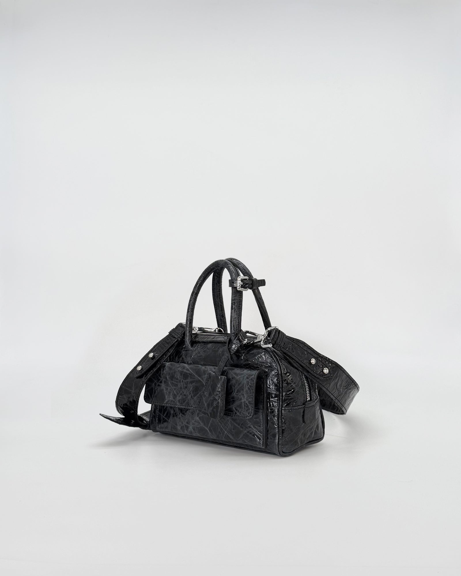Zoe Mini Vitello Strizzato black handbag with stylish details and adjustable strap.